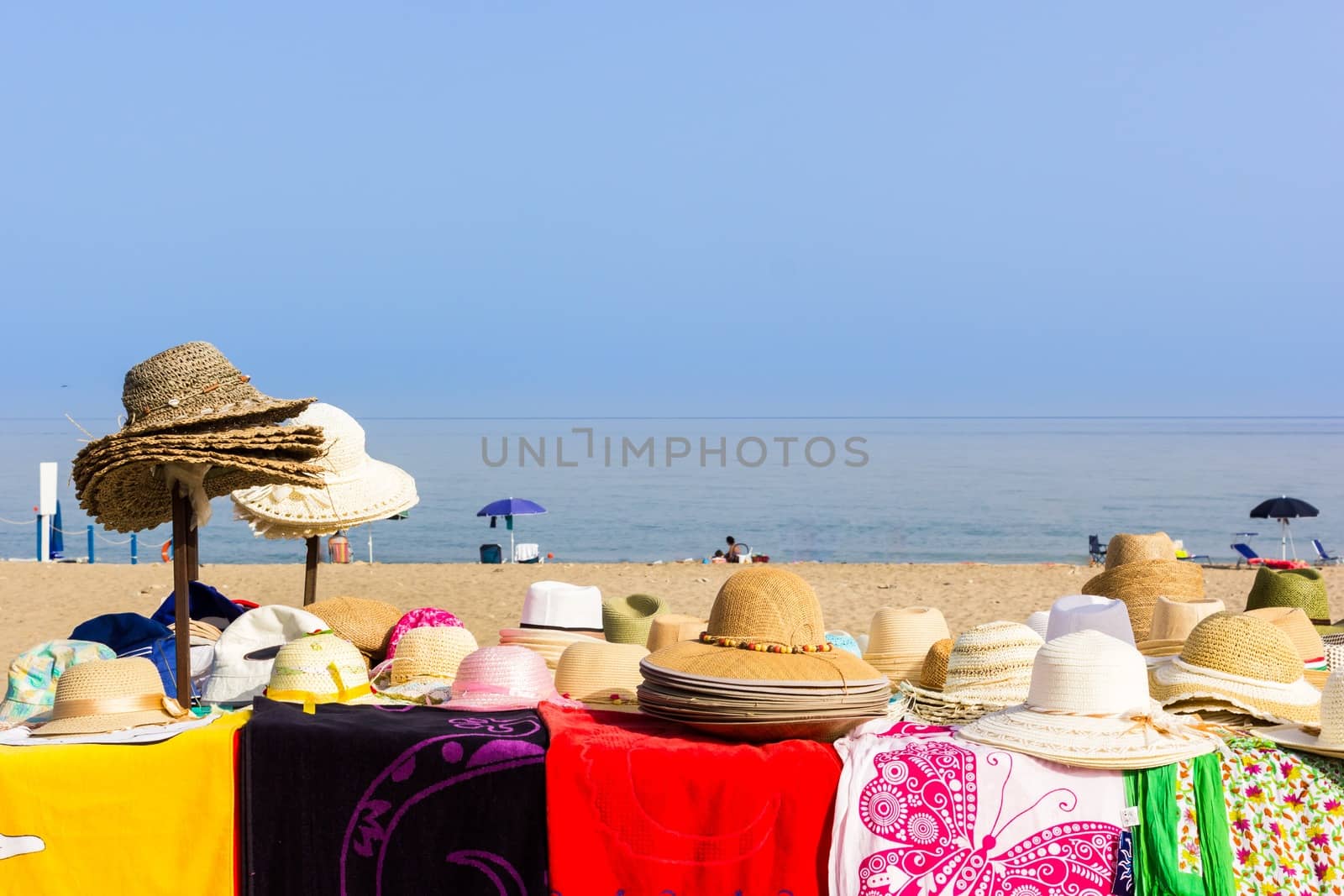 umbrellas at the beach with the sea in the summer sun 