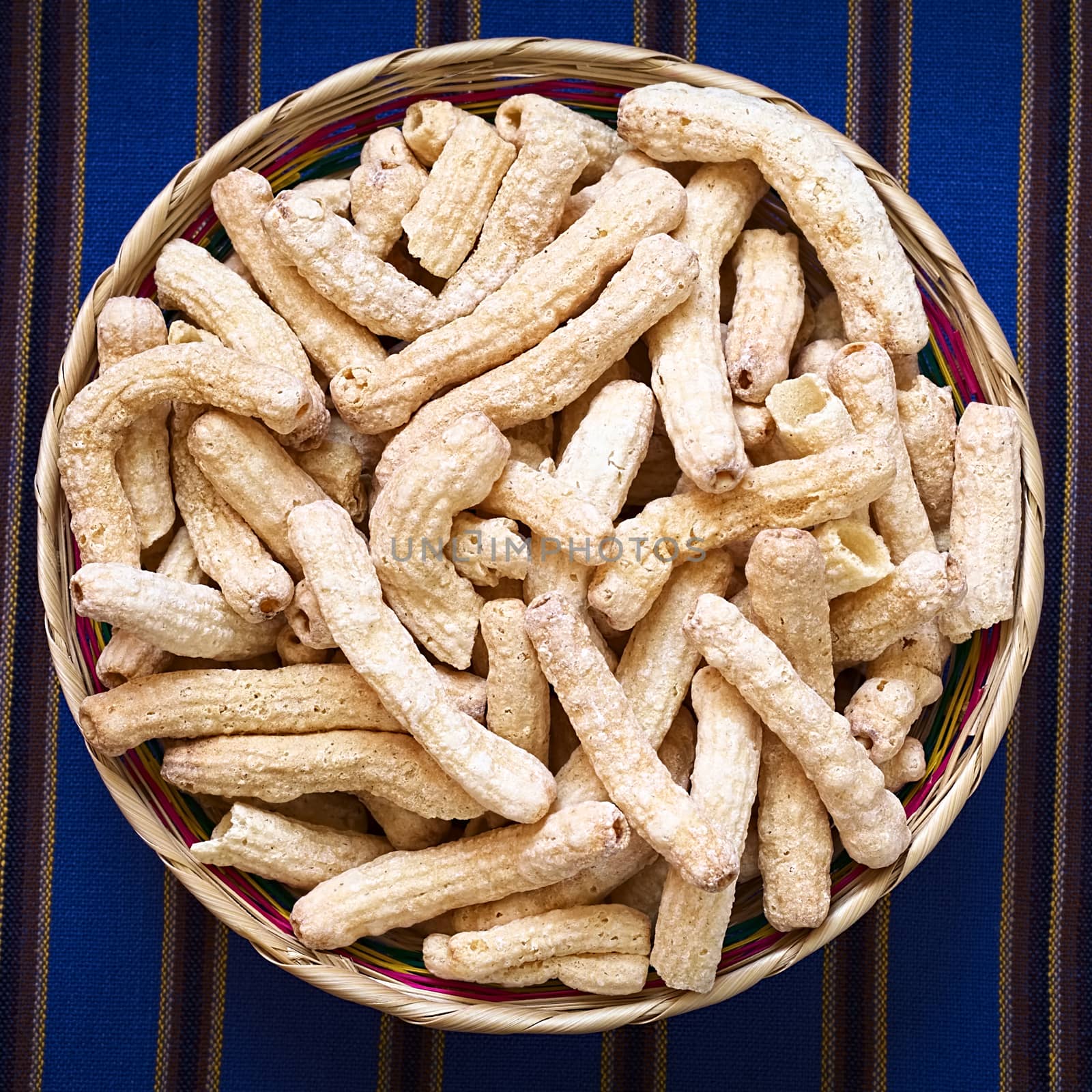 Sweetened popped pasta eaten as snack in Bolivia served in woven basket, photographed with natural light 