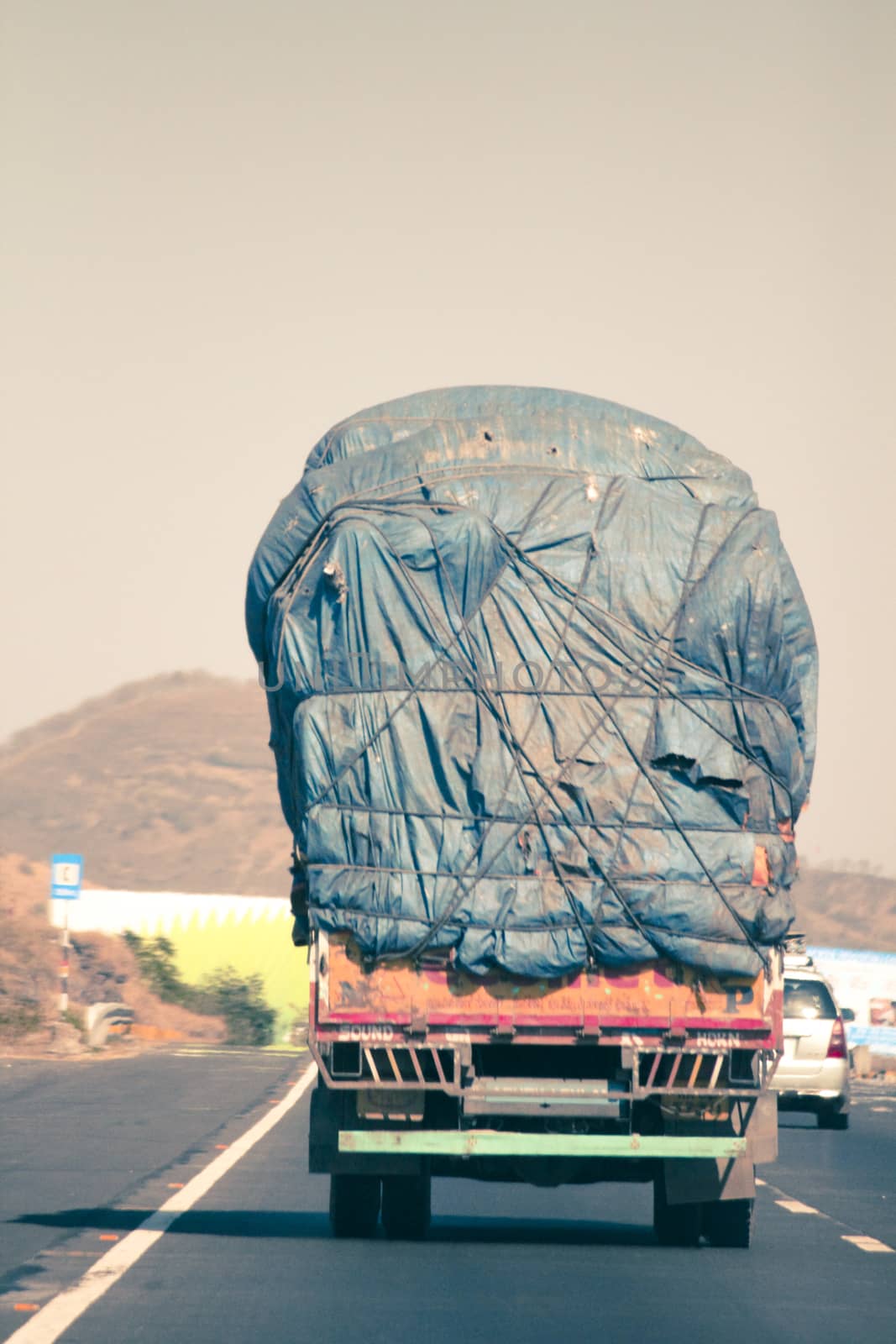 Overloaded indian lorry driving on the national highway 4