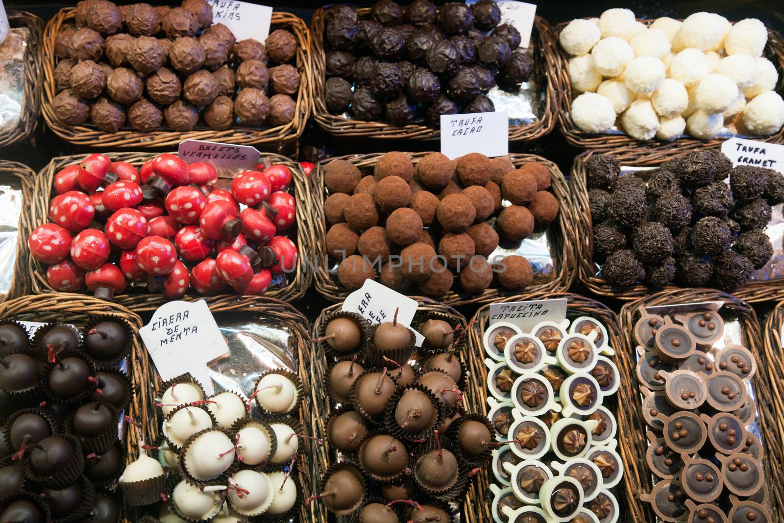 BARCELONA, SPAIN - APRIL 14: Famous La Boqueria market with nuts, chocolate delicacies, fruit jellies and dry fruits on April 14, 2012 in Barcelona, Spain. One of the oldest markets in Europe that still exist. Established 1217.