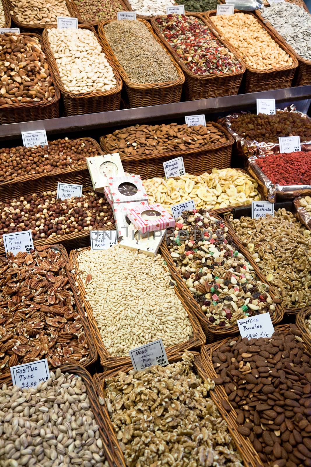 BARCELONA, SPAIN - APRIL 14: Famous La Boqueria market with nuts, chocolate delicacies, fruit jellies and dry fruits on April 14, 2012 in Barcelona, Spain. One of the oldest markets in Europe that still exist. Established 1217.