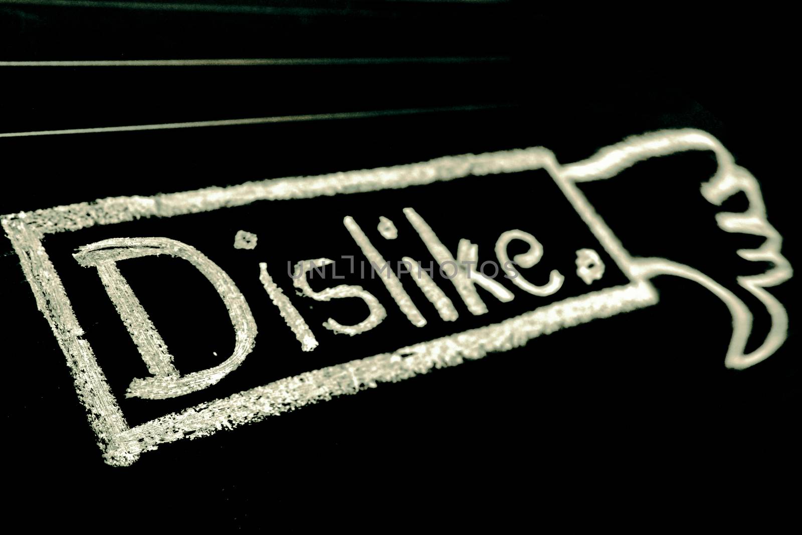 Dislike word handwritten on black chalkboard