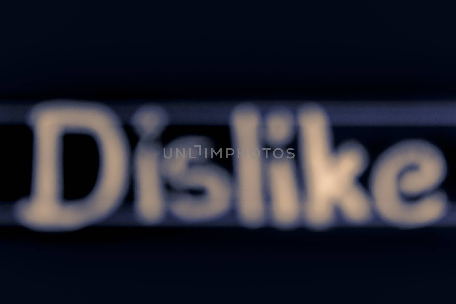 blur image of dislike word handwritten on black chalkboard