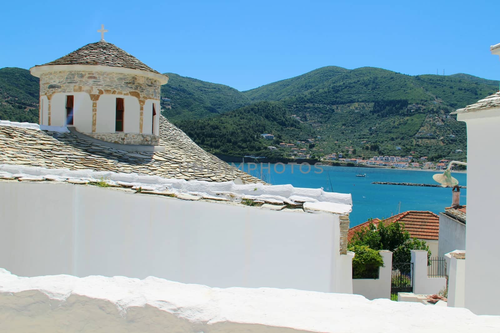 Photo shows Greek old village houses and their surroundings.