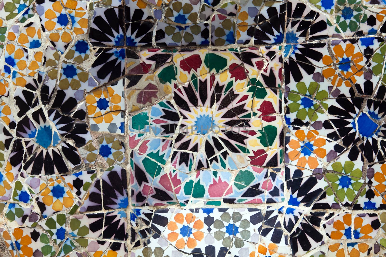 Old ceramic tiles in Park Guell - Barcelona, Spain by Portokalis