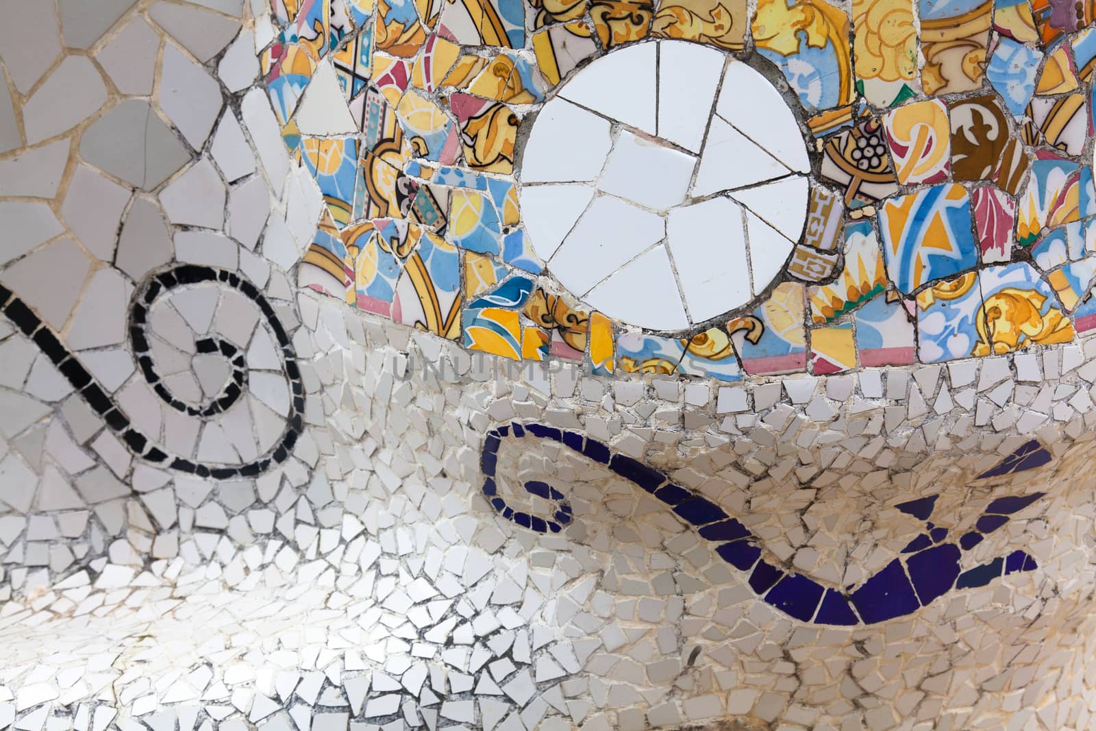 Old ceramic tiles in Park Guell - Barcelona, Spain by Portokalis