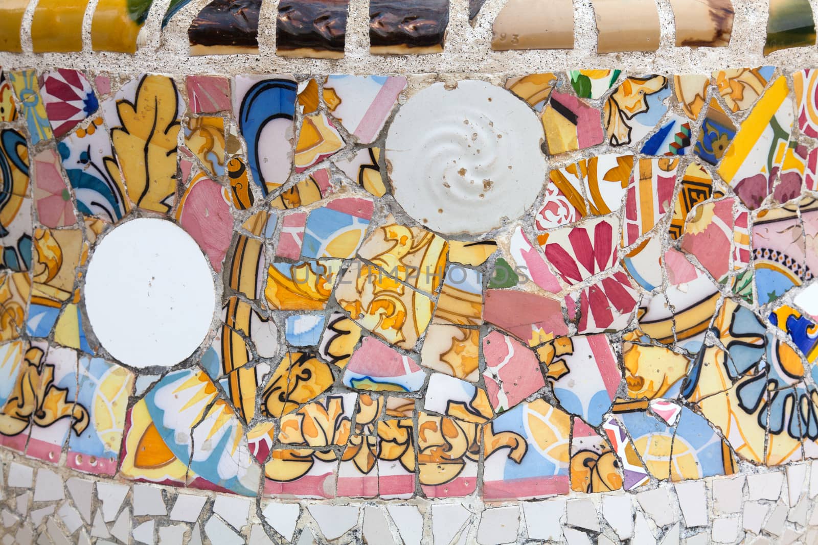 Old ceramic tiles in Park Guell - Barcelona, Spain by Portokalis