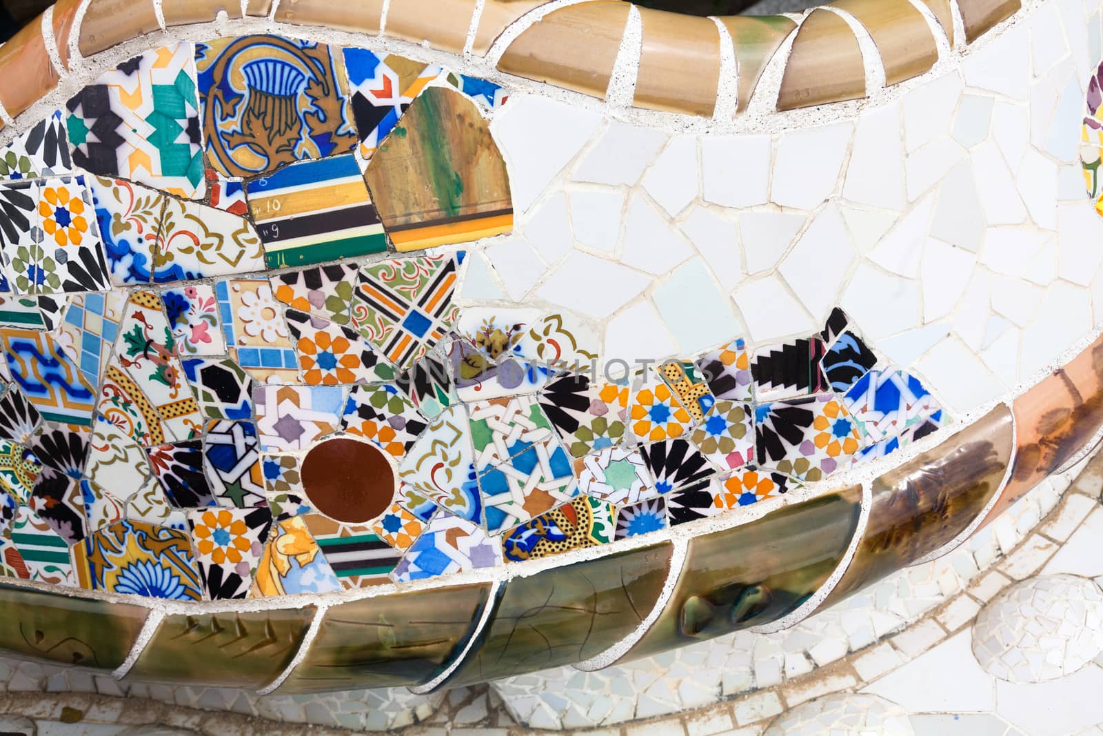 Old ceramic tiles in Park Guell - Barcelona, Spain by Portokalis