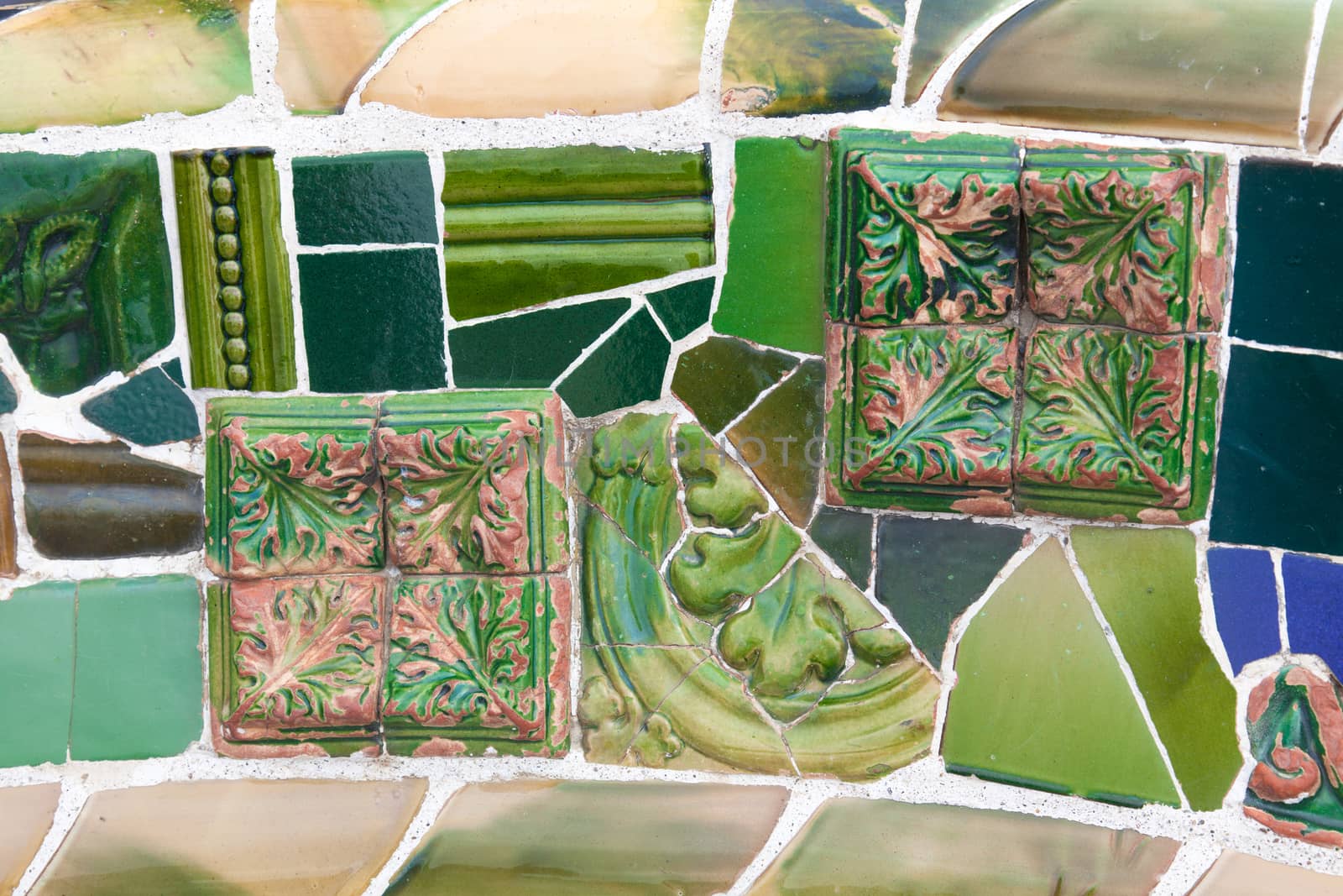 Old ceramic tiles in Park Guell - Barcelona, Spain by Portokalis