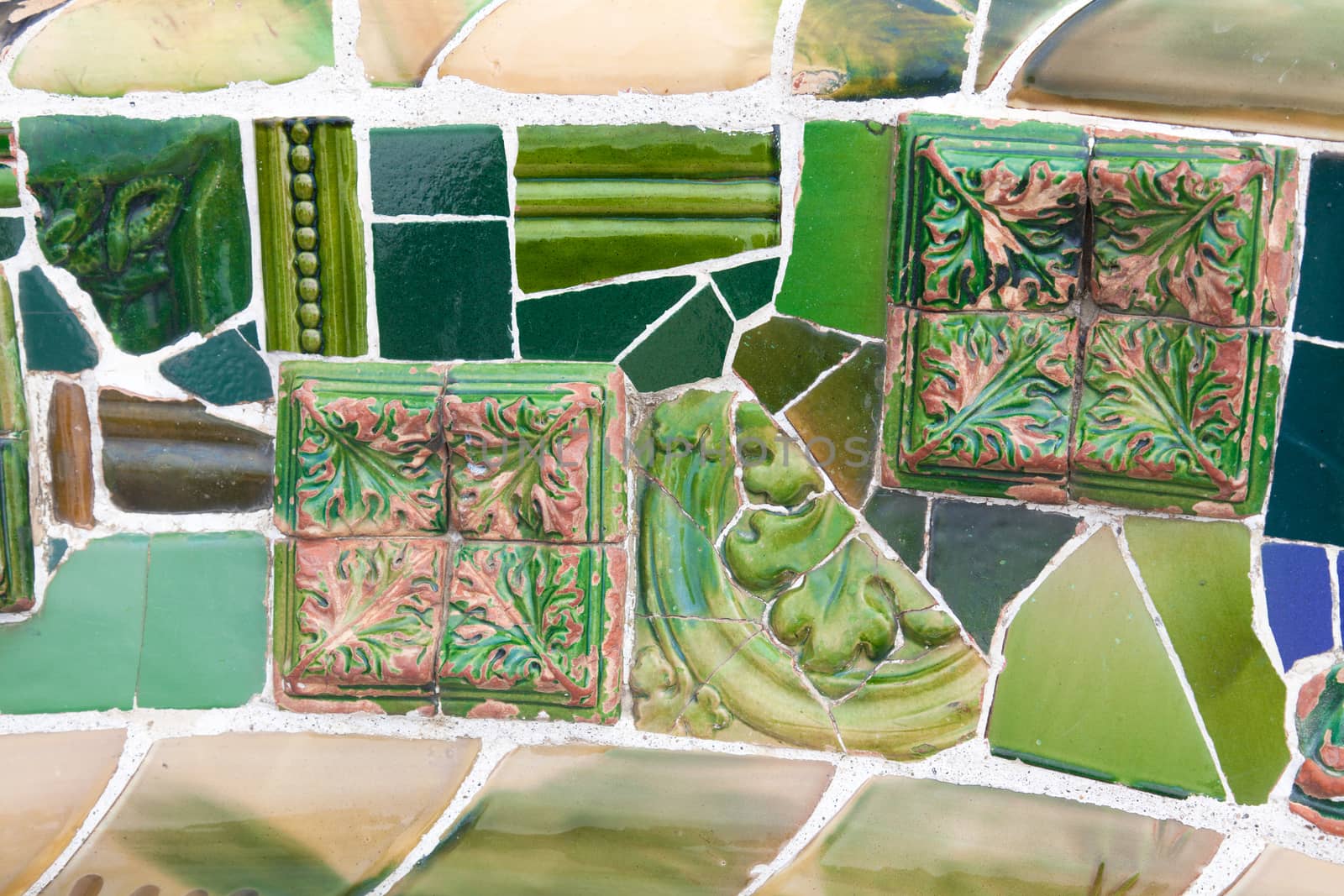 Old ceramic tiles in Park Guell - Barcelona, Spain by Portokalis