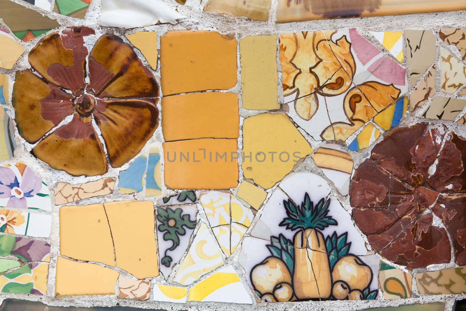 Old ceramic tiles in Park Guell - Barcelona, Spain by Portokalis