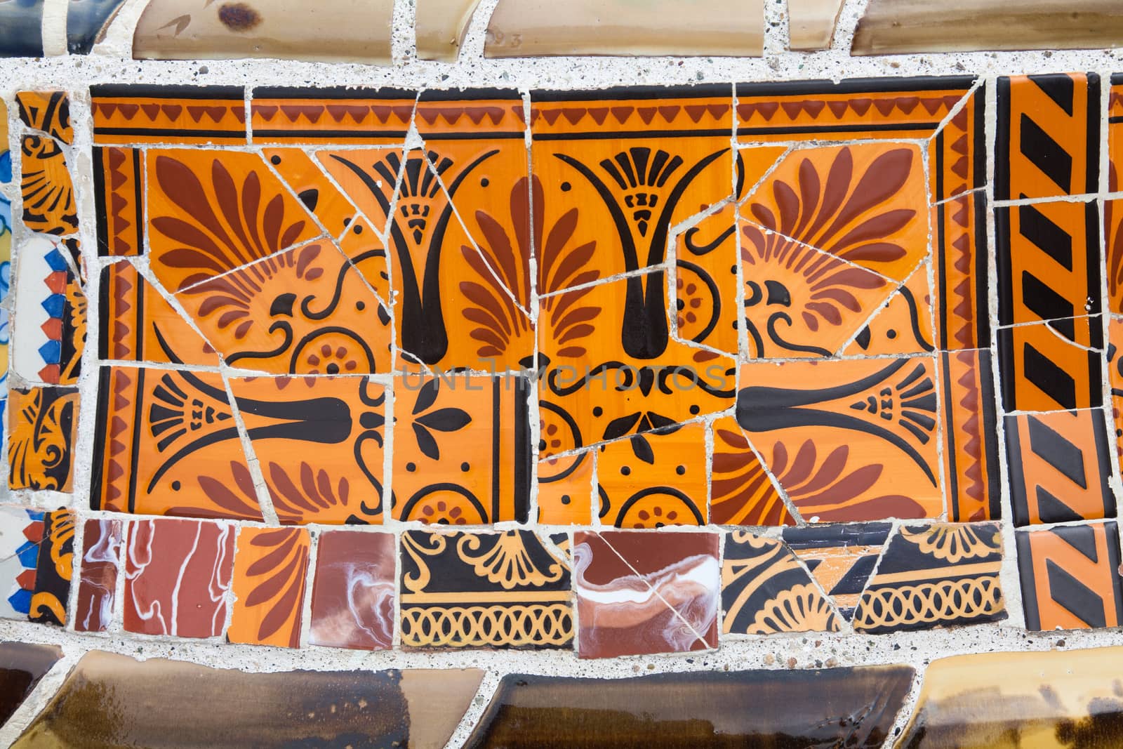 Old ceramic tiles in Park Guell - Barcelona, Spain by Portokalis