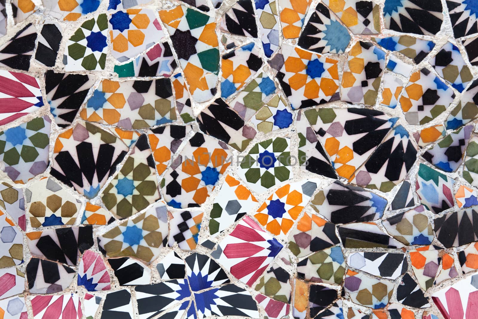 Old ceramic tiles in Park Guell - Barcelona, Spain by Portokalis