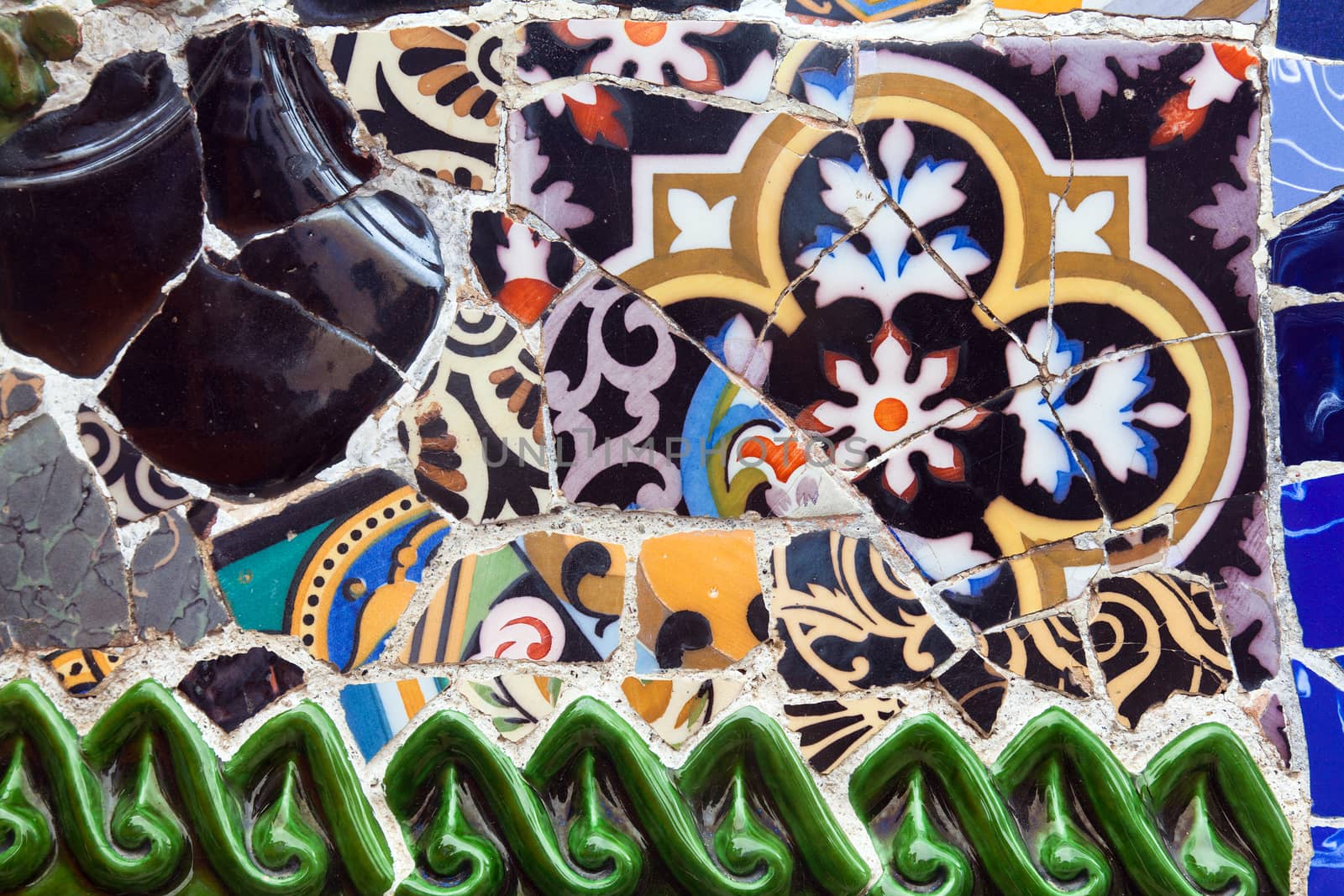 Old ceramic tiles in Park Guell - Barcelona, Spain by Portokalis