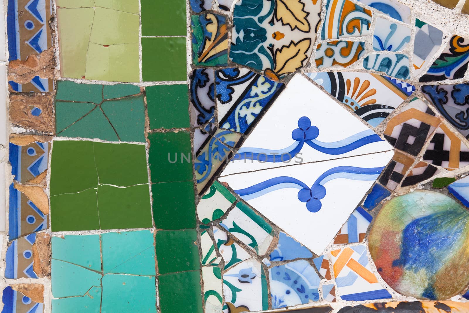 Old ceramic tiles in Park Guell - Barcelona, Spain by Portokalis