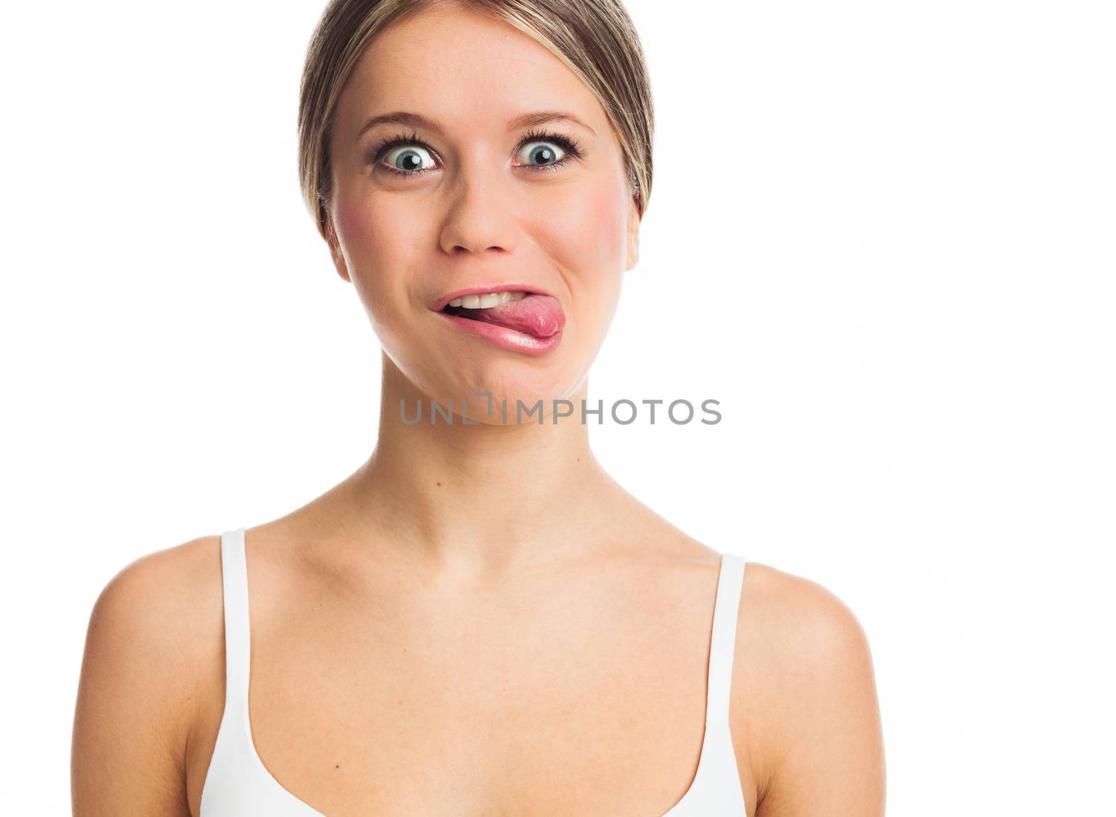Portrait of a funny young woman sticking tongue out