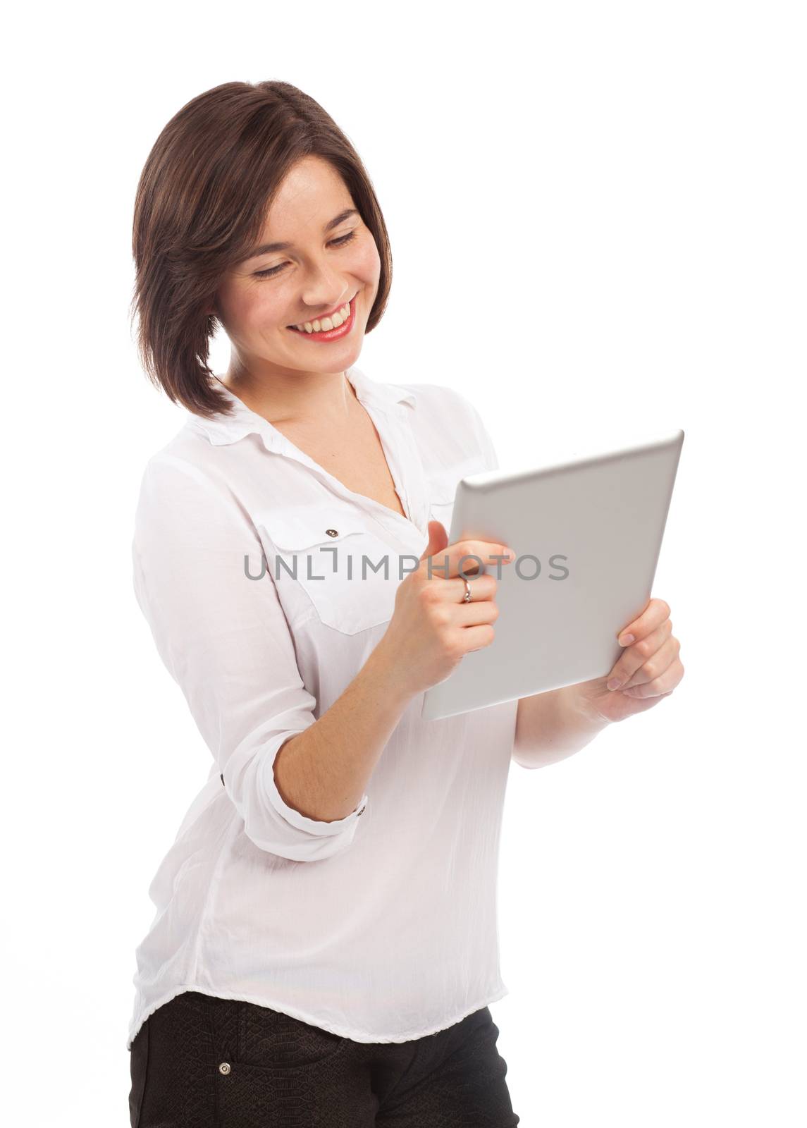 Young smiling brunette holding and reading something on a touchpad, isolated on white