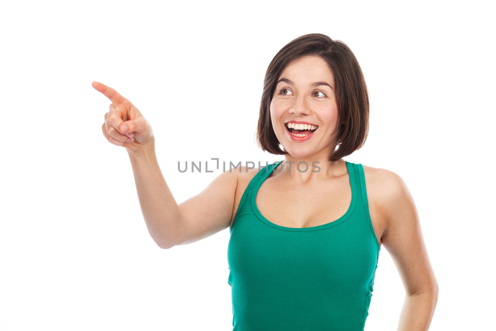 Joyful young woman showing something with her finger, isolated on white 