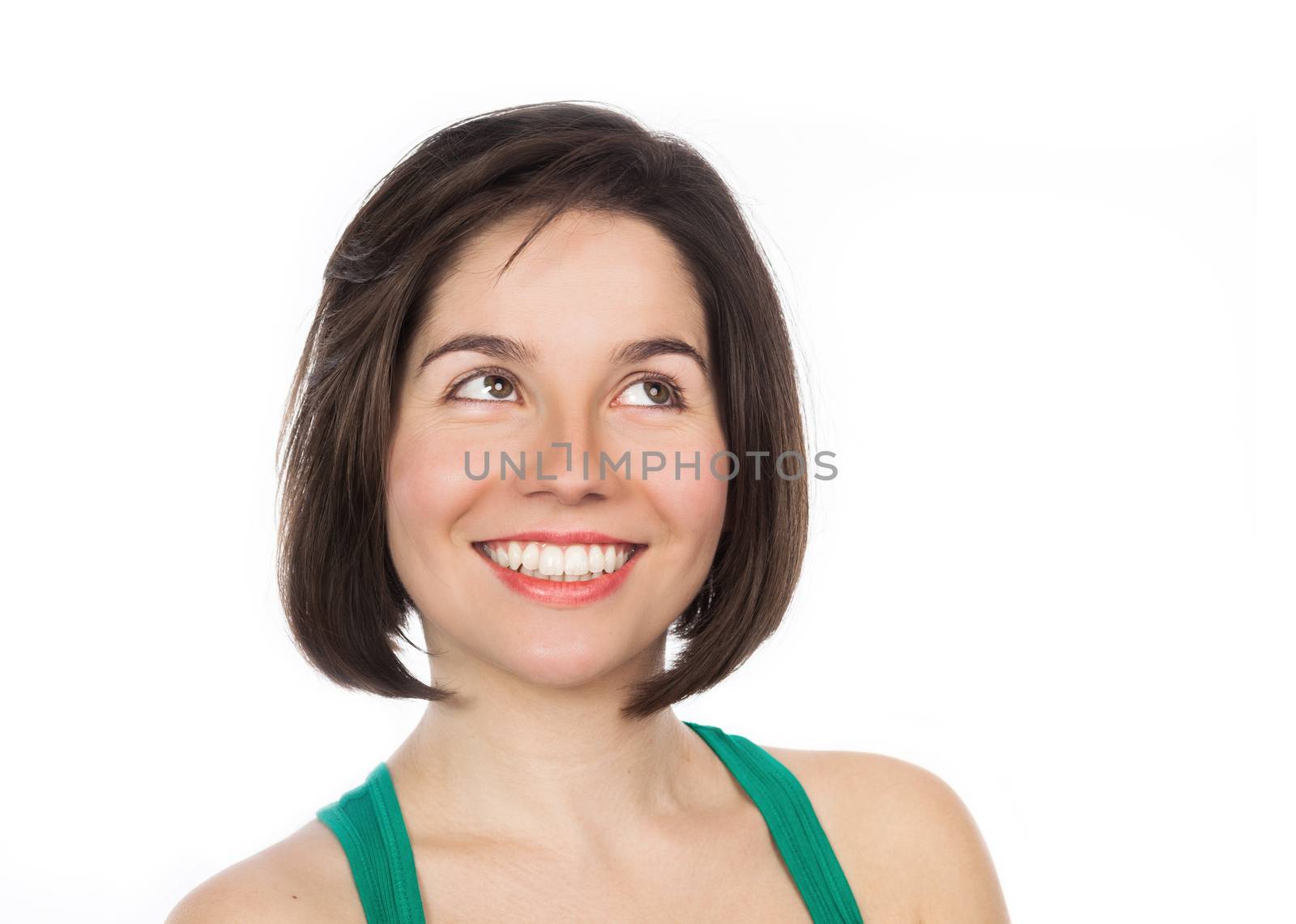 Close-up portrait of a young smiling woman looking up, isolated on white