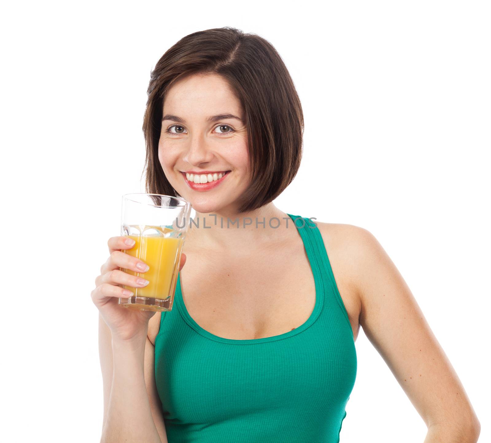 Portrait of a young brunette drinking an orange juice, isolated on white