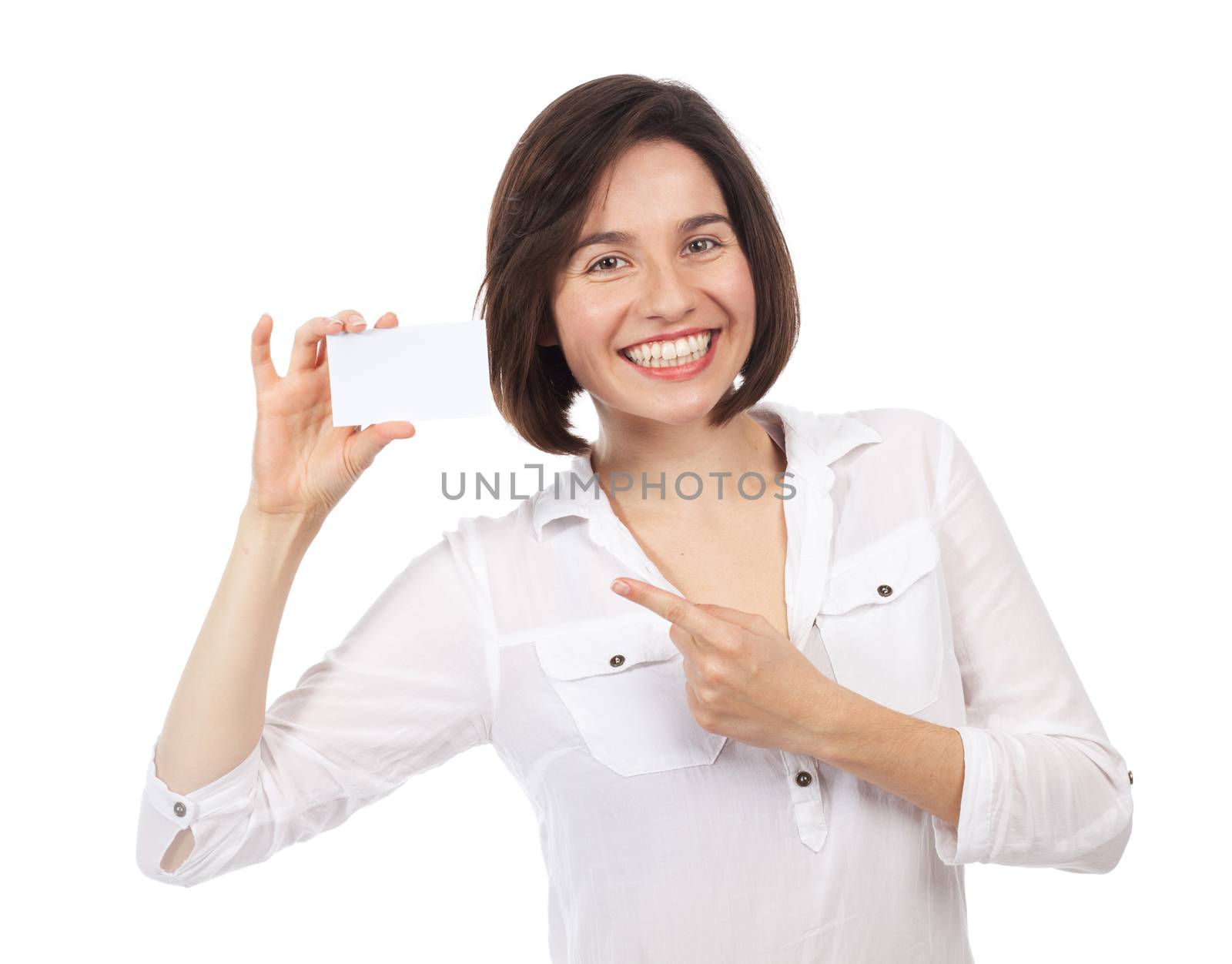 Pretty young woman pointing a blank business card, isolated on white