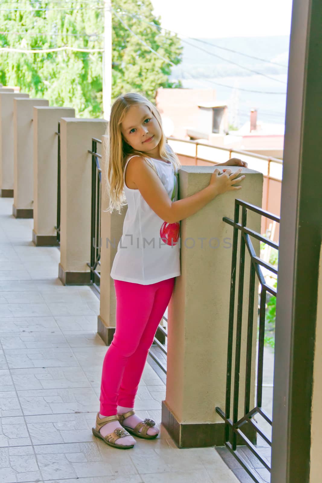 Cute girl with blond long hair and blue eyes