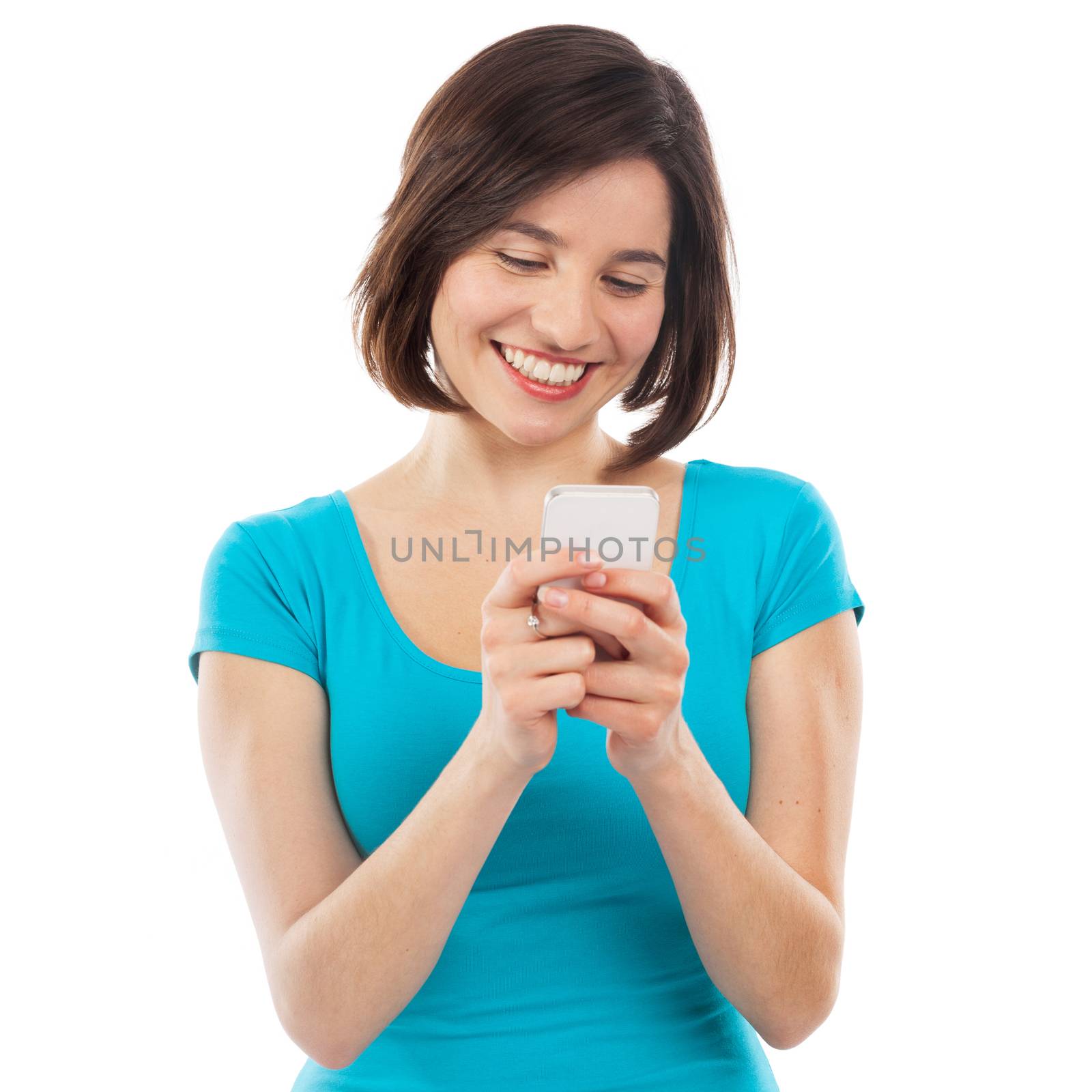 Beautiful girl writing a message on her phone, isolated on white