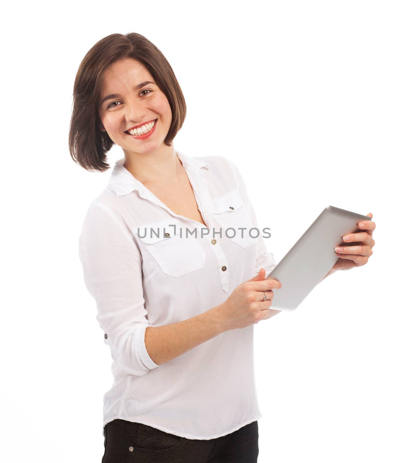 Young smiling brunette using an electronic tablet, isolated on white