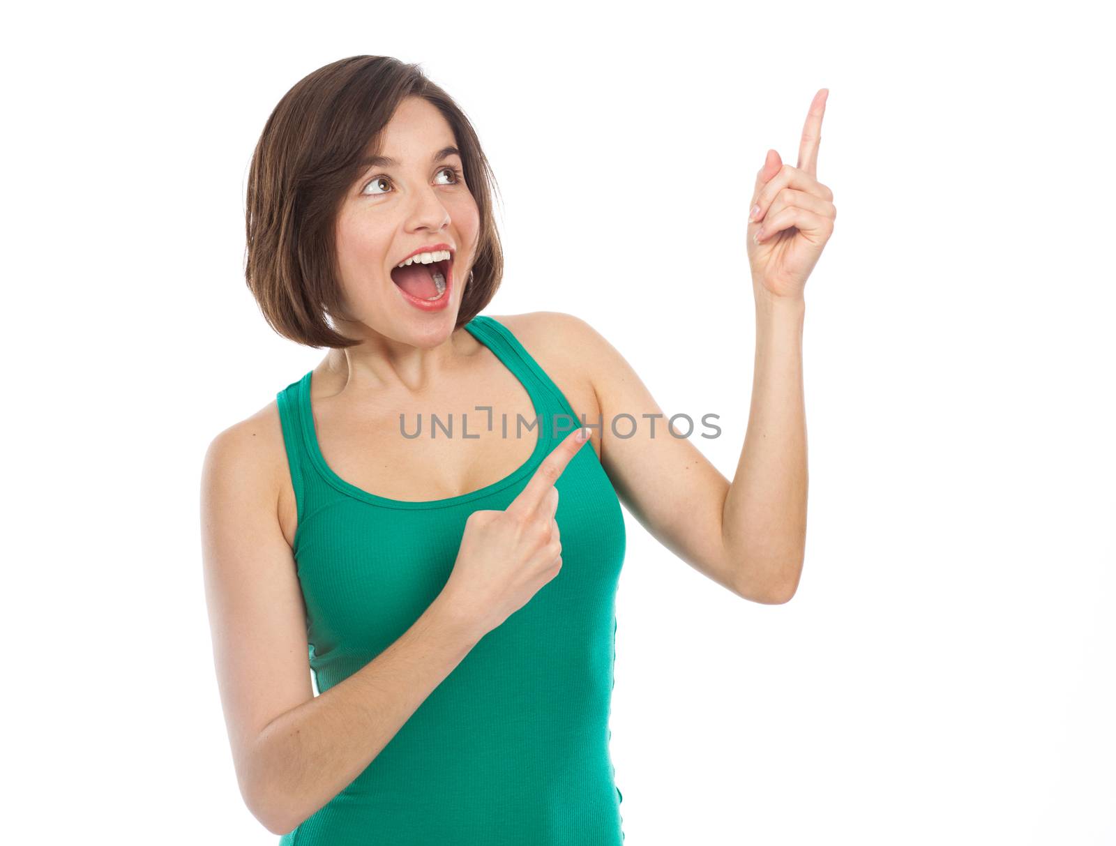 Cheerful young woman showing something with her finger, isolated on white 