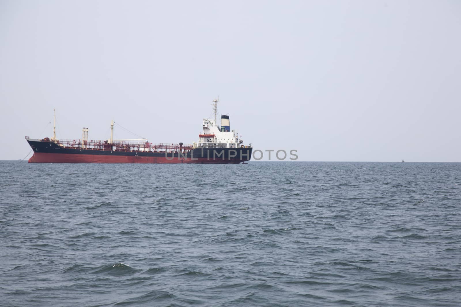 Large cargo ship Boats moored in the sea to make sense compared to the coast.