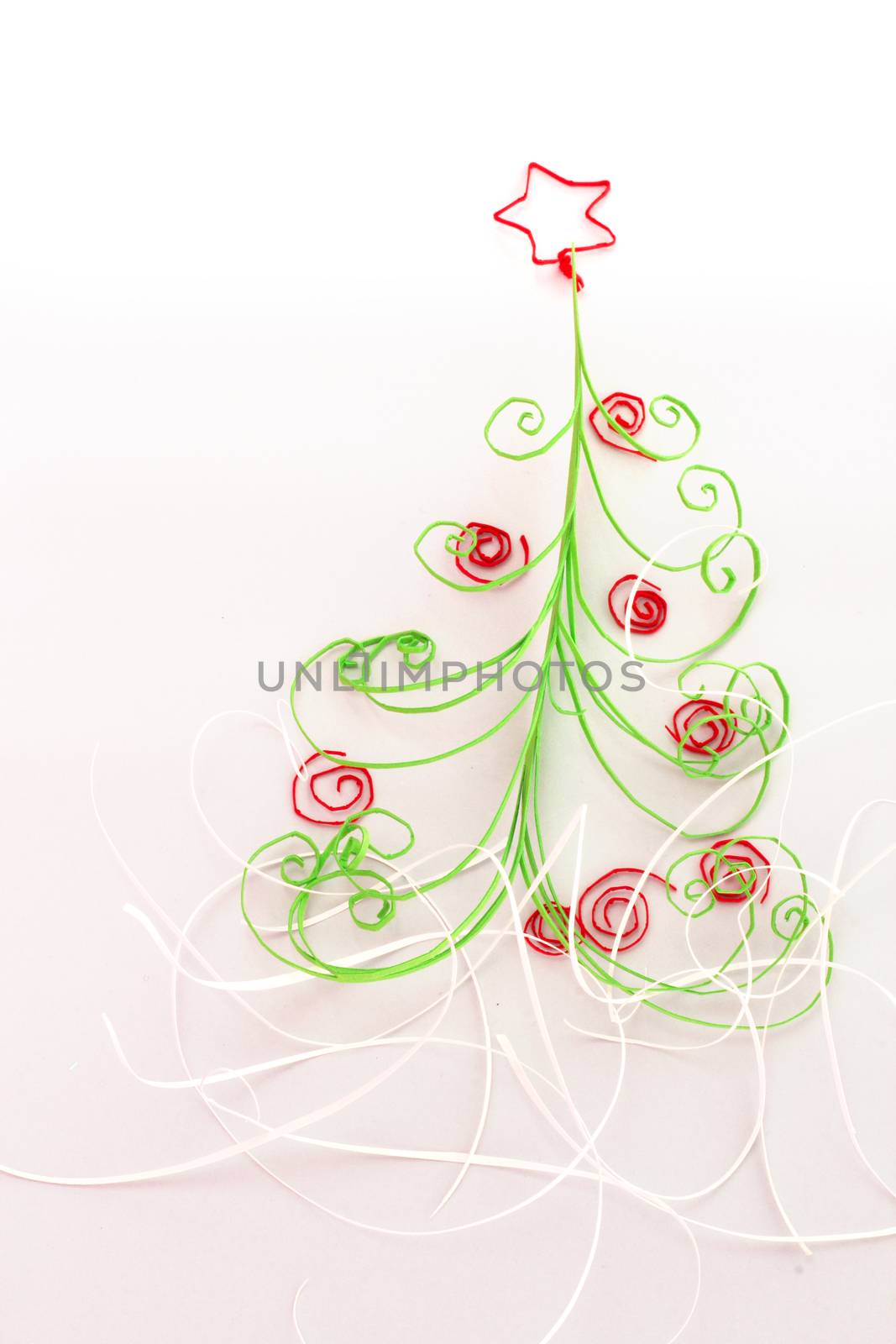 Paper christmas fir tree with red decoration on white background