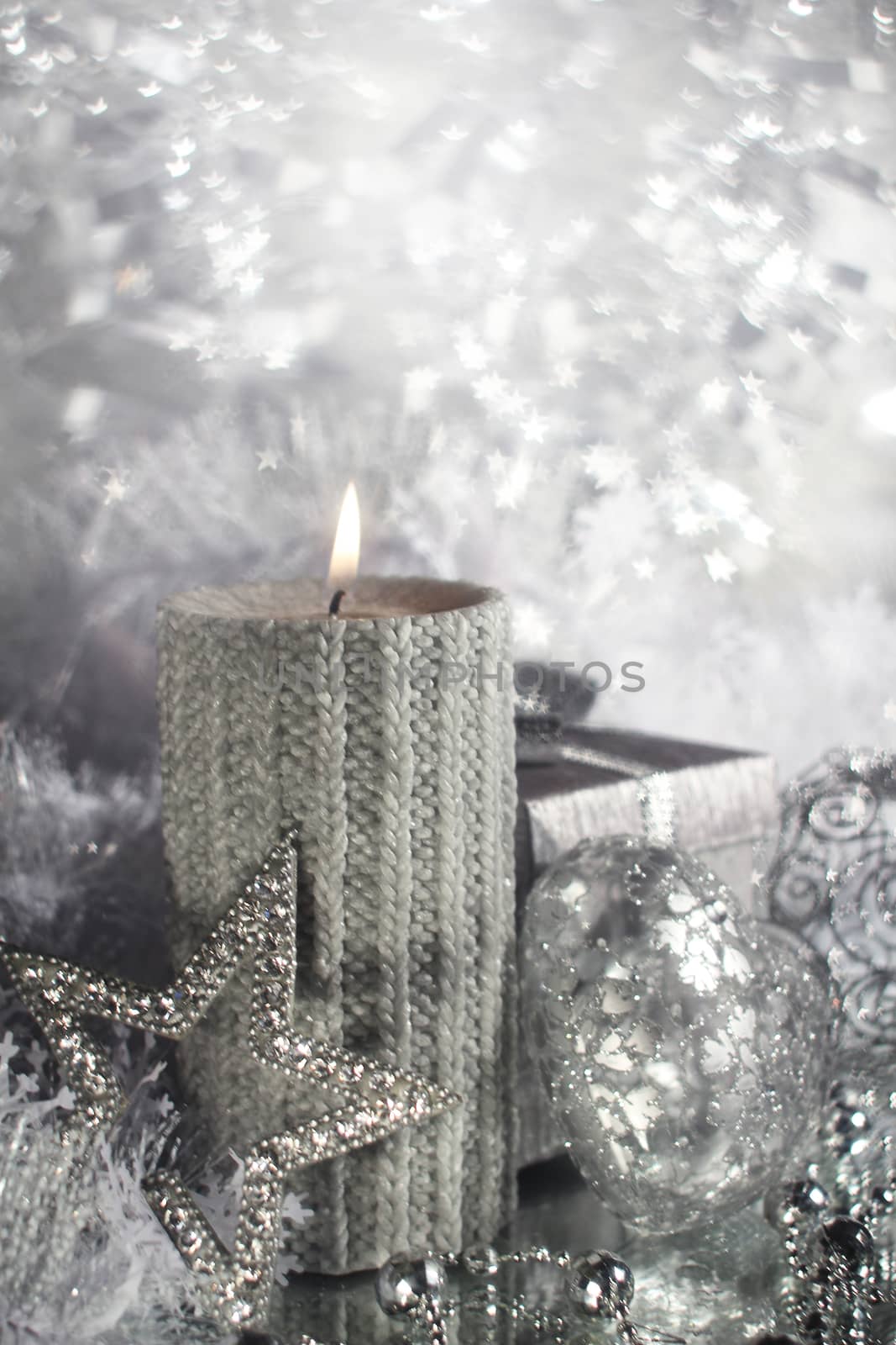 Beautiful shiny silver christmas decor and burning candle