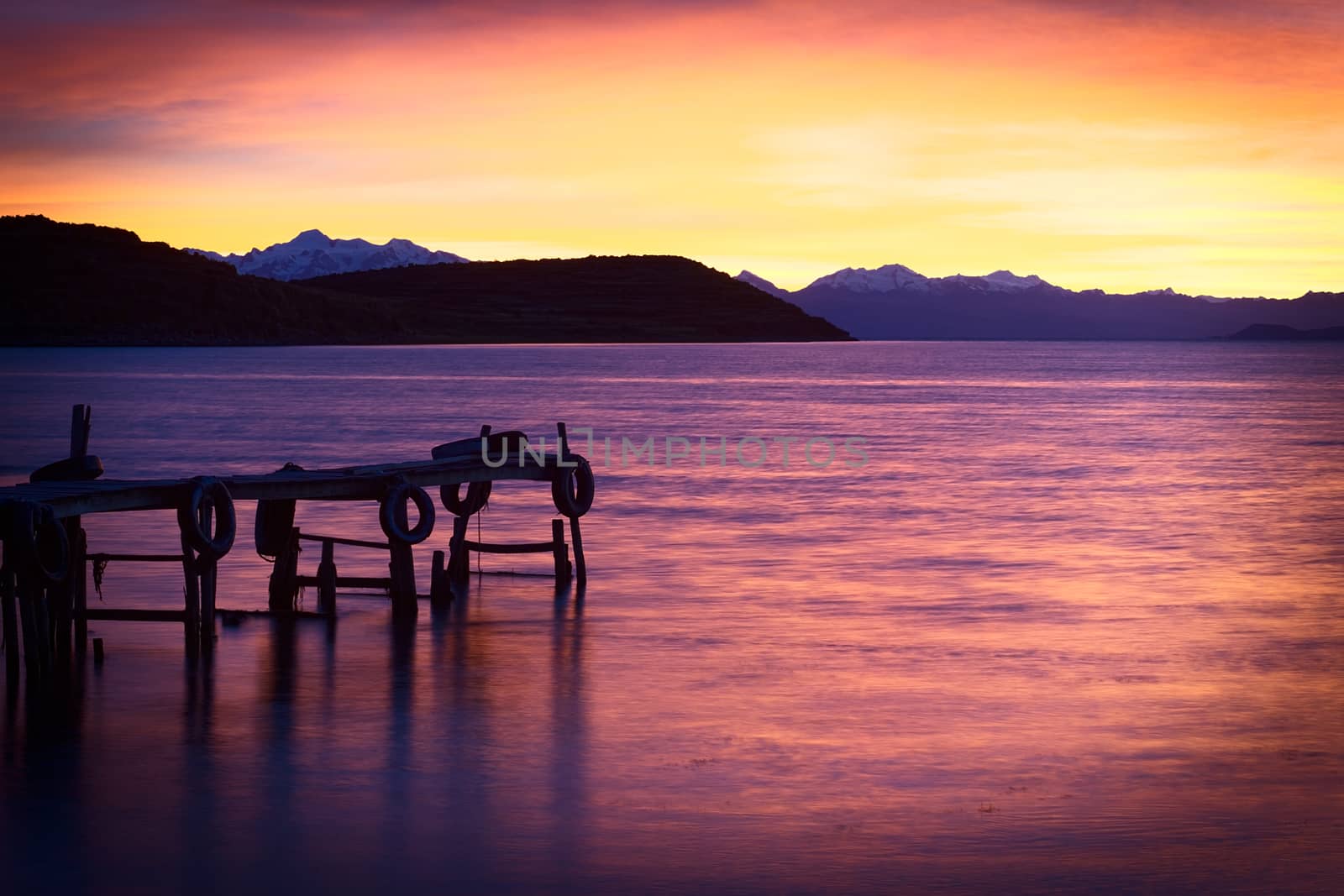 Sunrise over Lake Titicaca in the bay of Cha'lla with view onto the snow-capped mountains of the Andes in the back photographed from the small village of Cha'llapampa on the Northwestern part of the Isla del Sol (Island of the Sun) in Bolivia