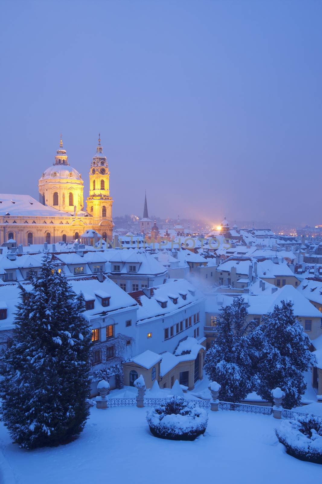 prague - view of hradcany castle and st. nicolaus church in winter