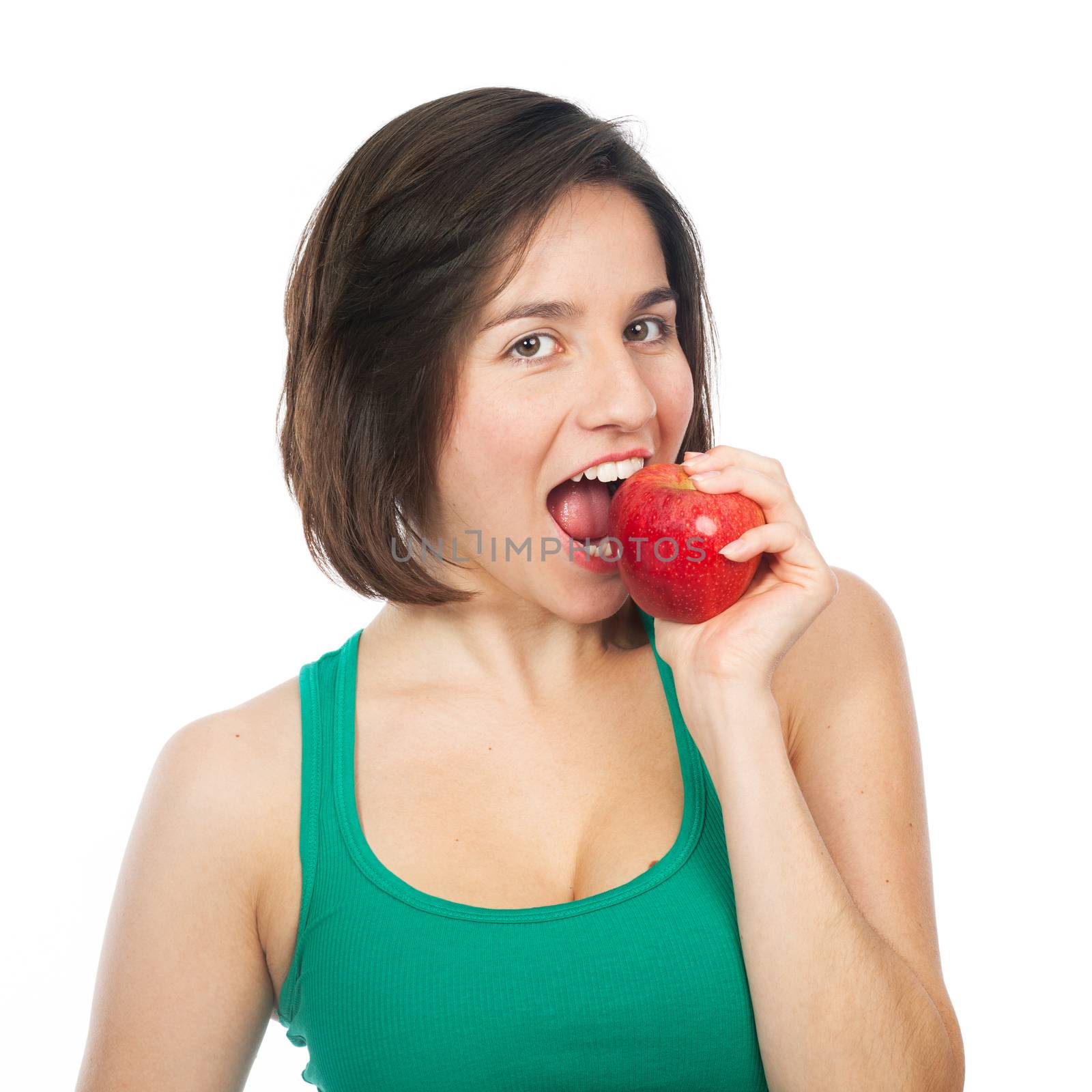 Beautiful young woman eating a red apple, isolated on white