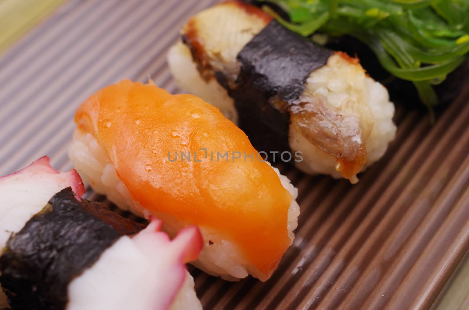 Sushi nigiri in dish with bamboo sticks 