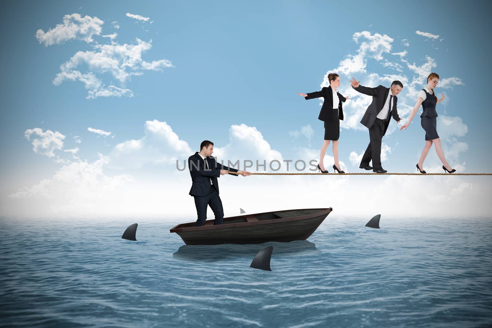 Young businessman pulling a tightrope for business people by Wavebreakmedia