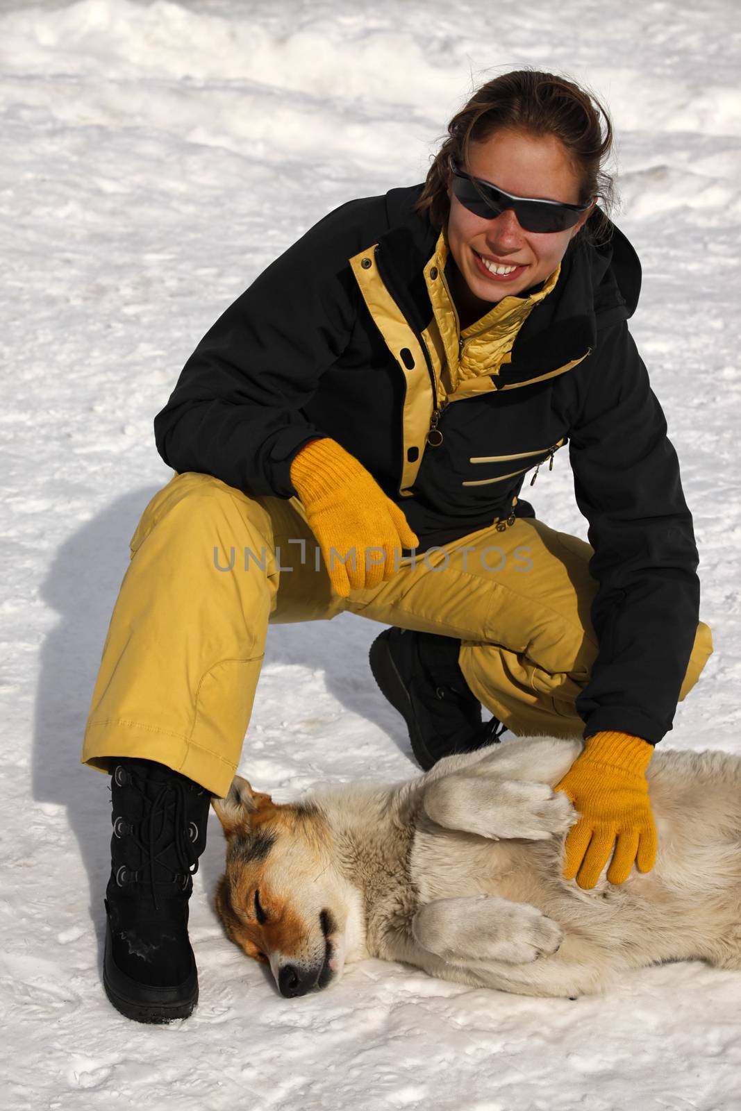 Young woman with a stray dog in winter