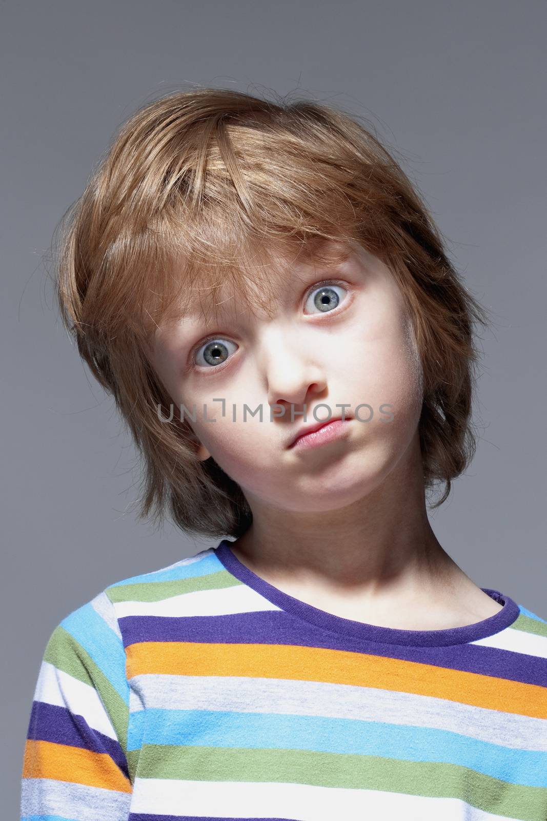 Portrait of a Boy with Blond Hair Looking - Isolated on Gray