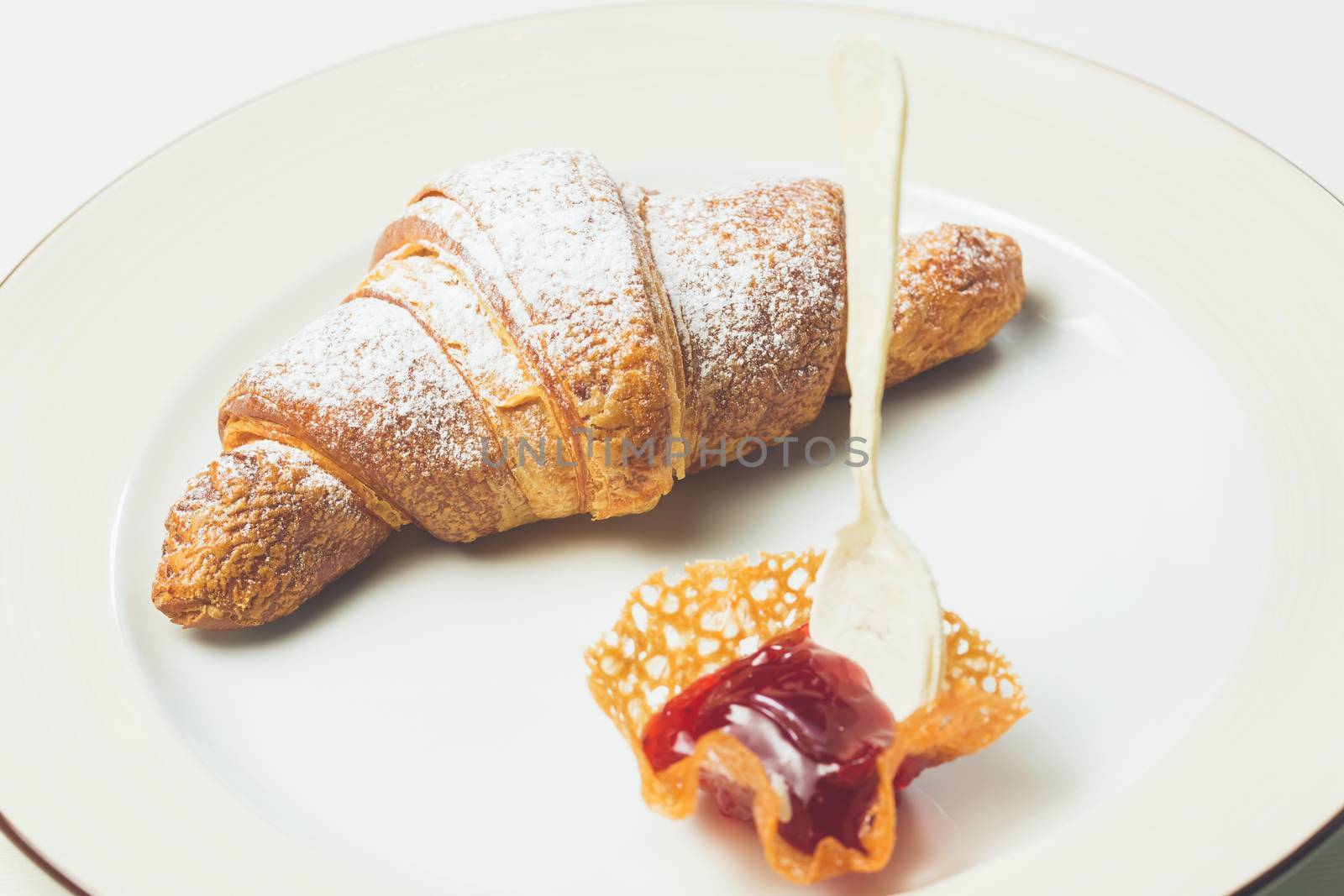 breakfast with croissant. Warm colors. Shallow dof. 