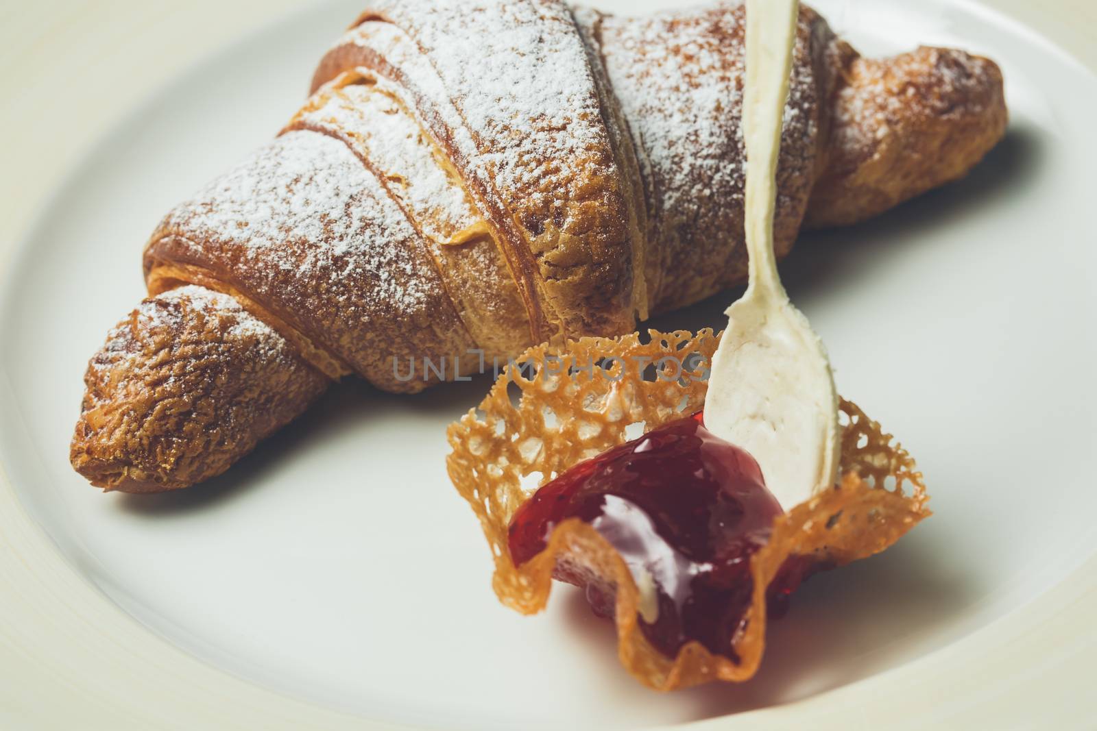 breakfast with croissant. Warm colors. Shallow dof. 