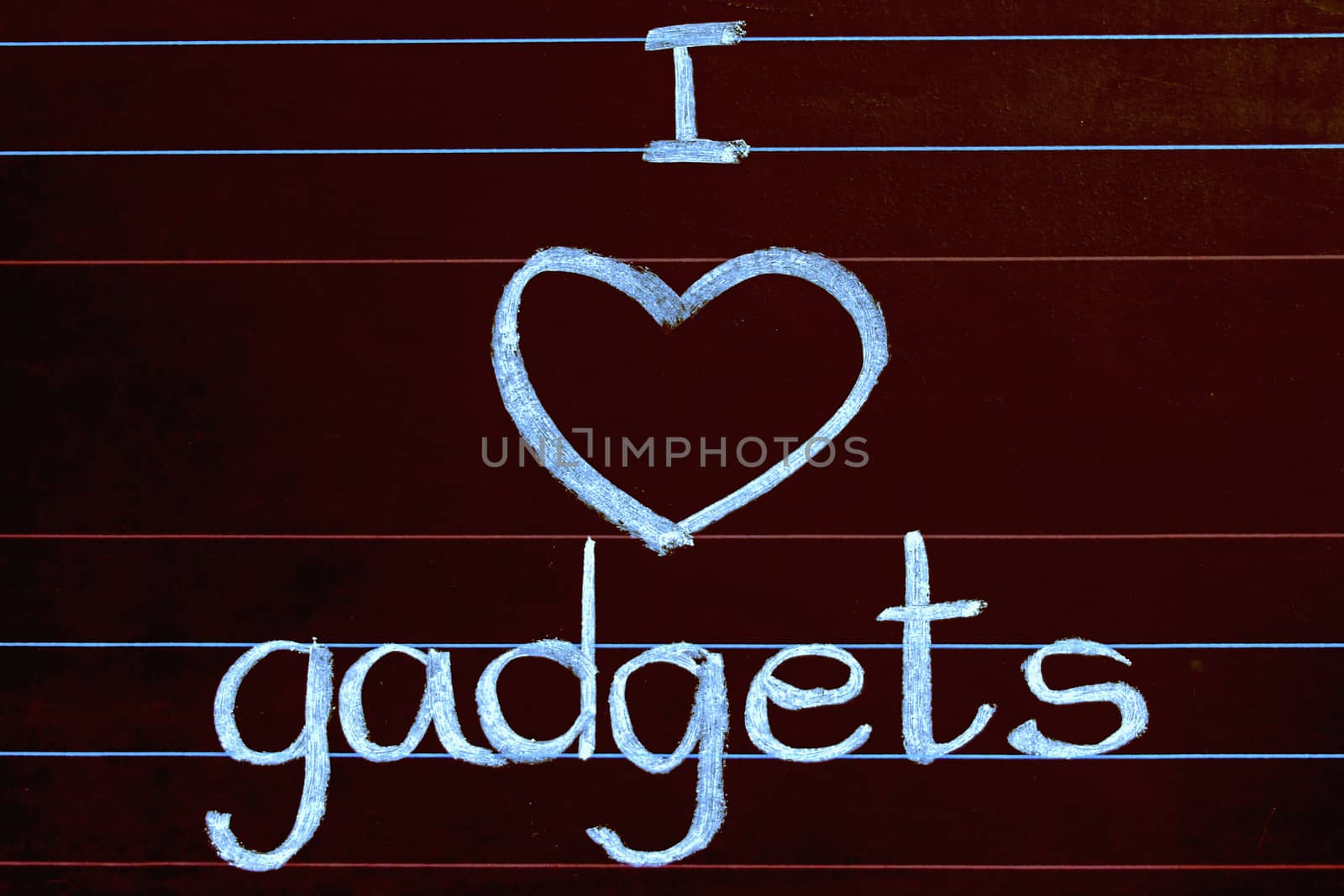 I Love gadgets phrase handwritten on blackboard by yands