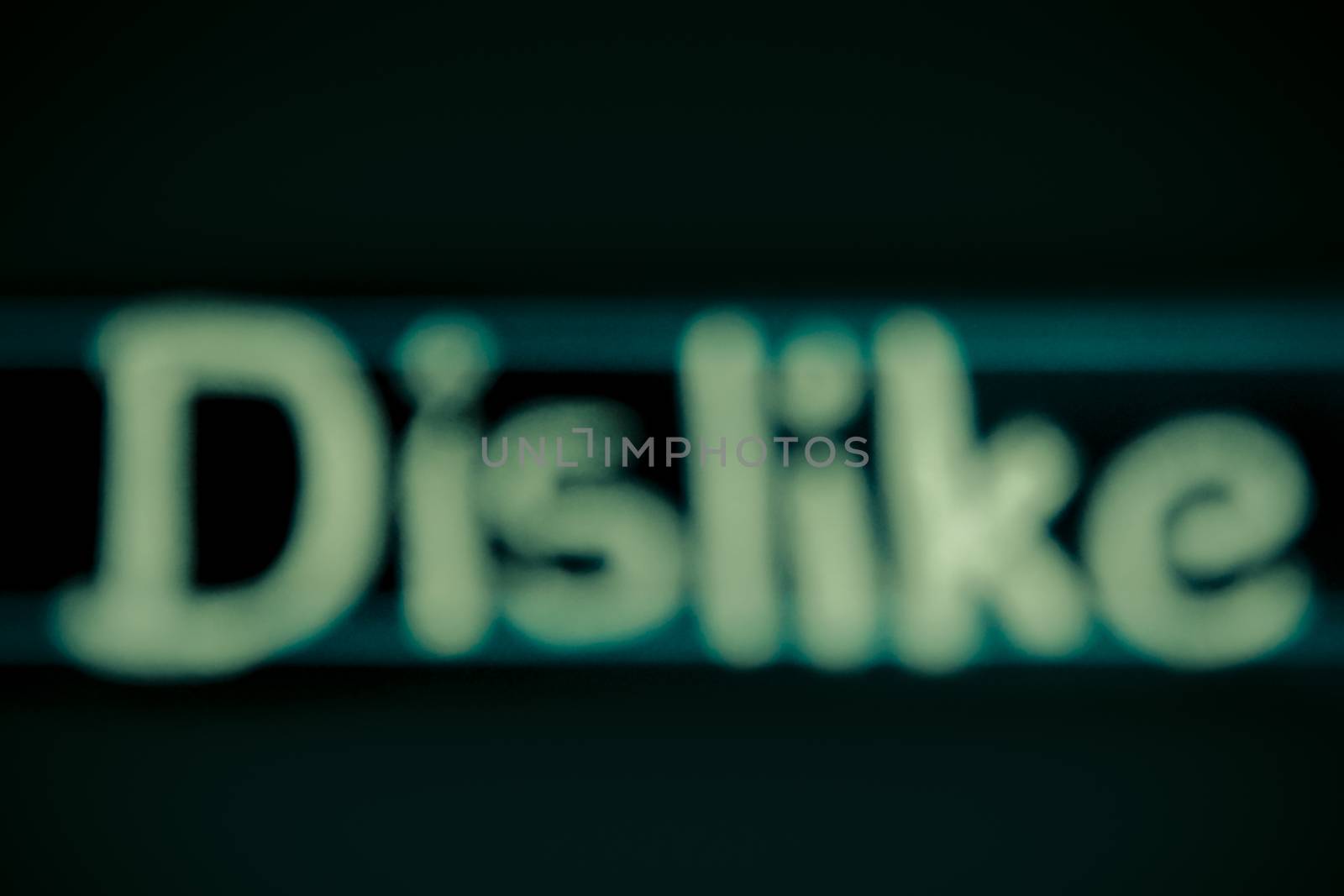 blur image of dislike word handwritten on black chalkboard