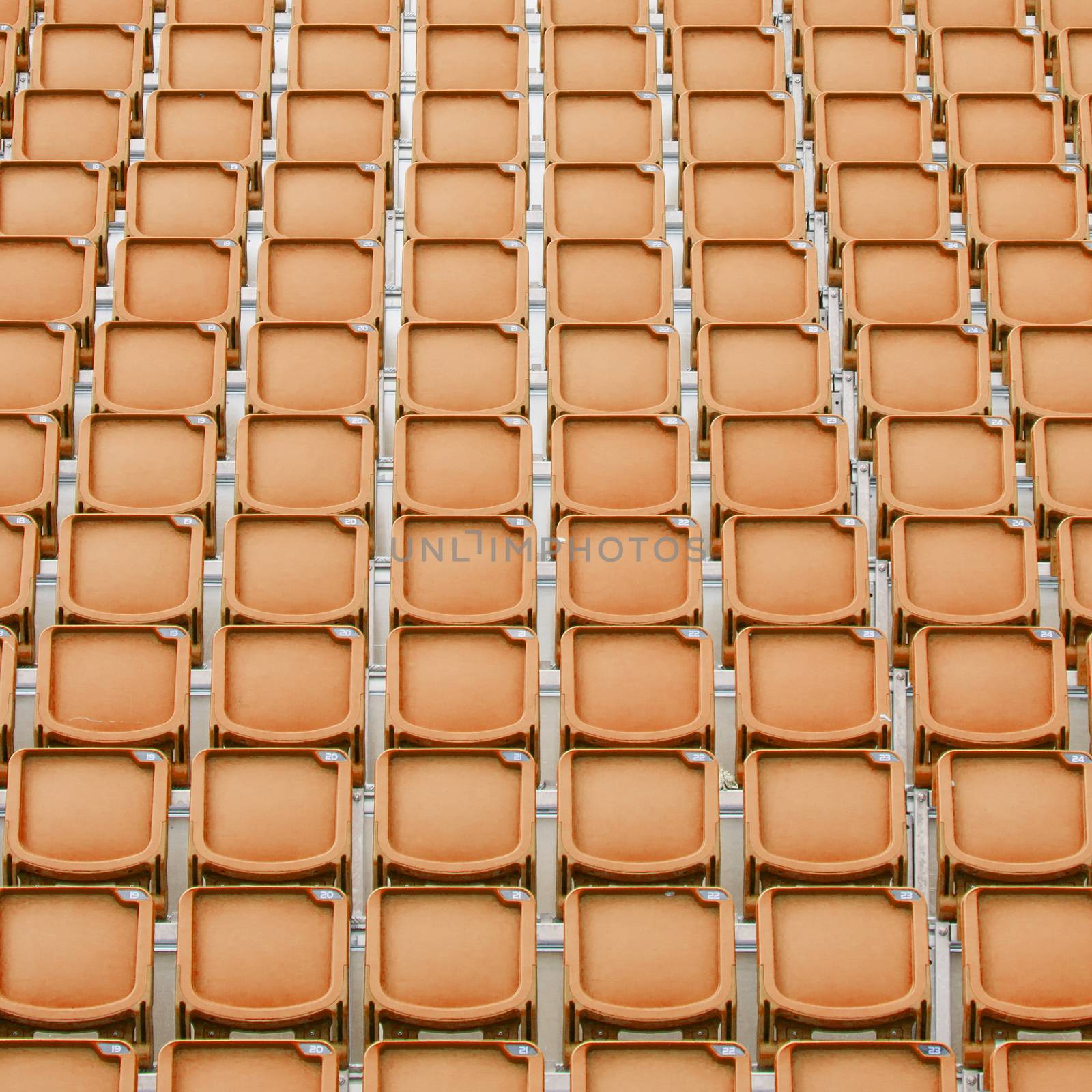 Orange seat in sport stadium, empty seats ready for the public