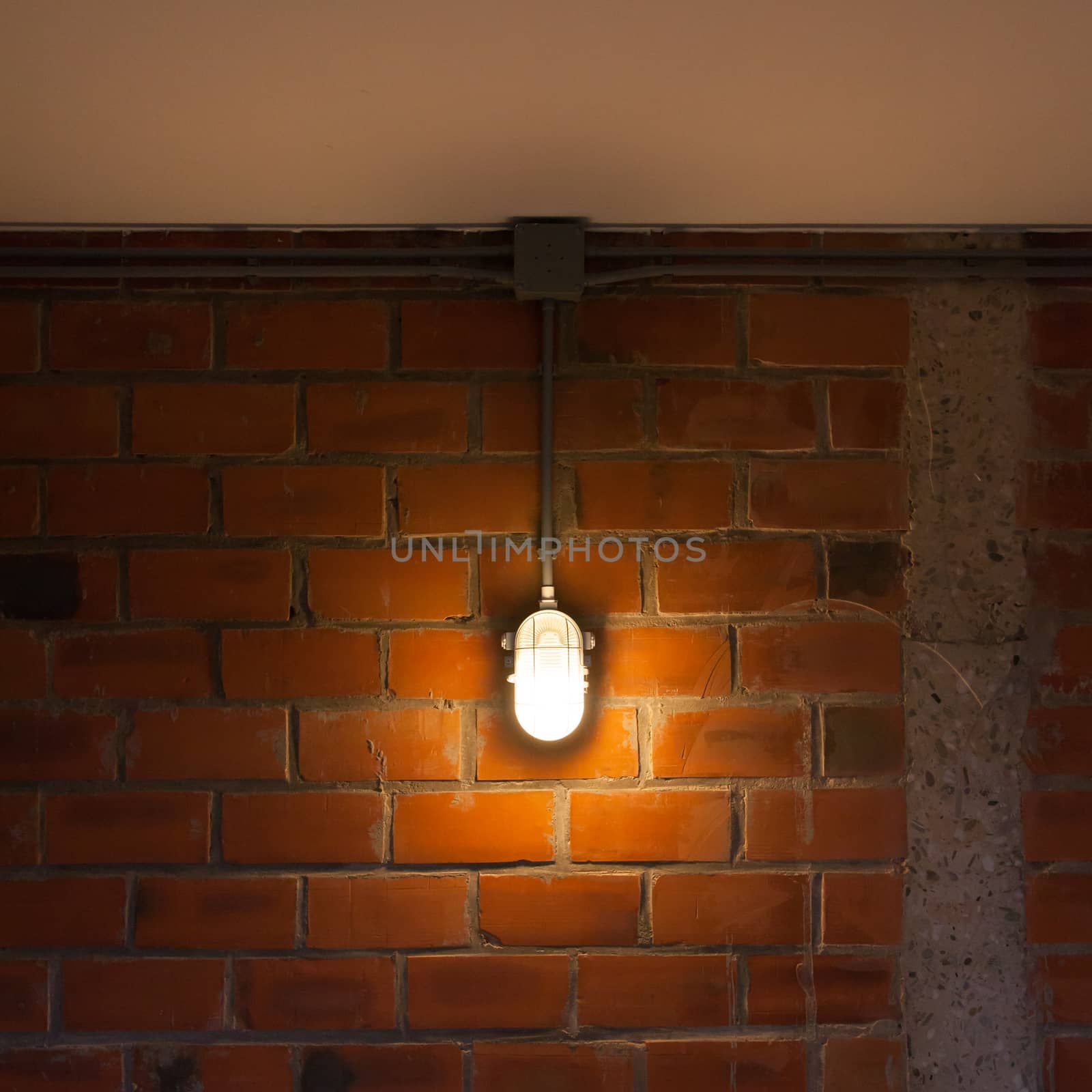 Old red brick wall with industrial light