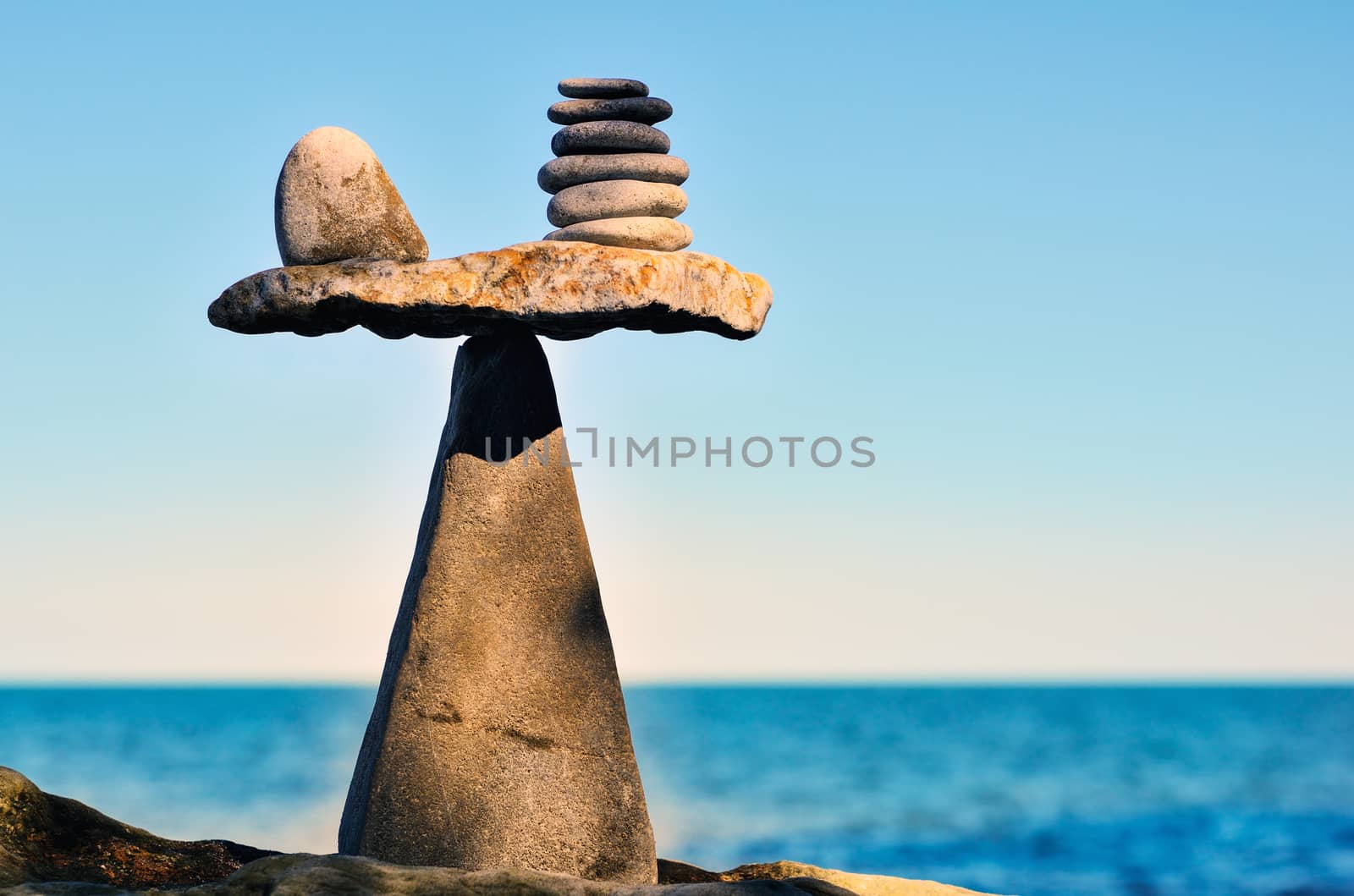 Balancing of pebbles on the top of triangle stone