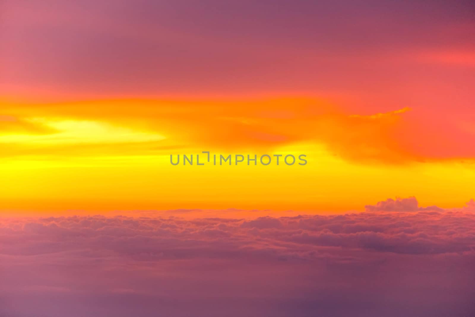 Sunset with clouds over view from airplane flying