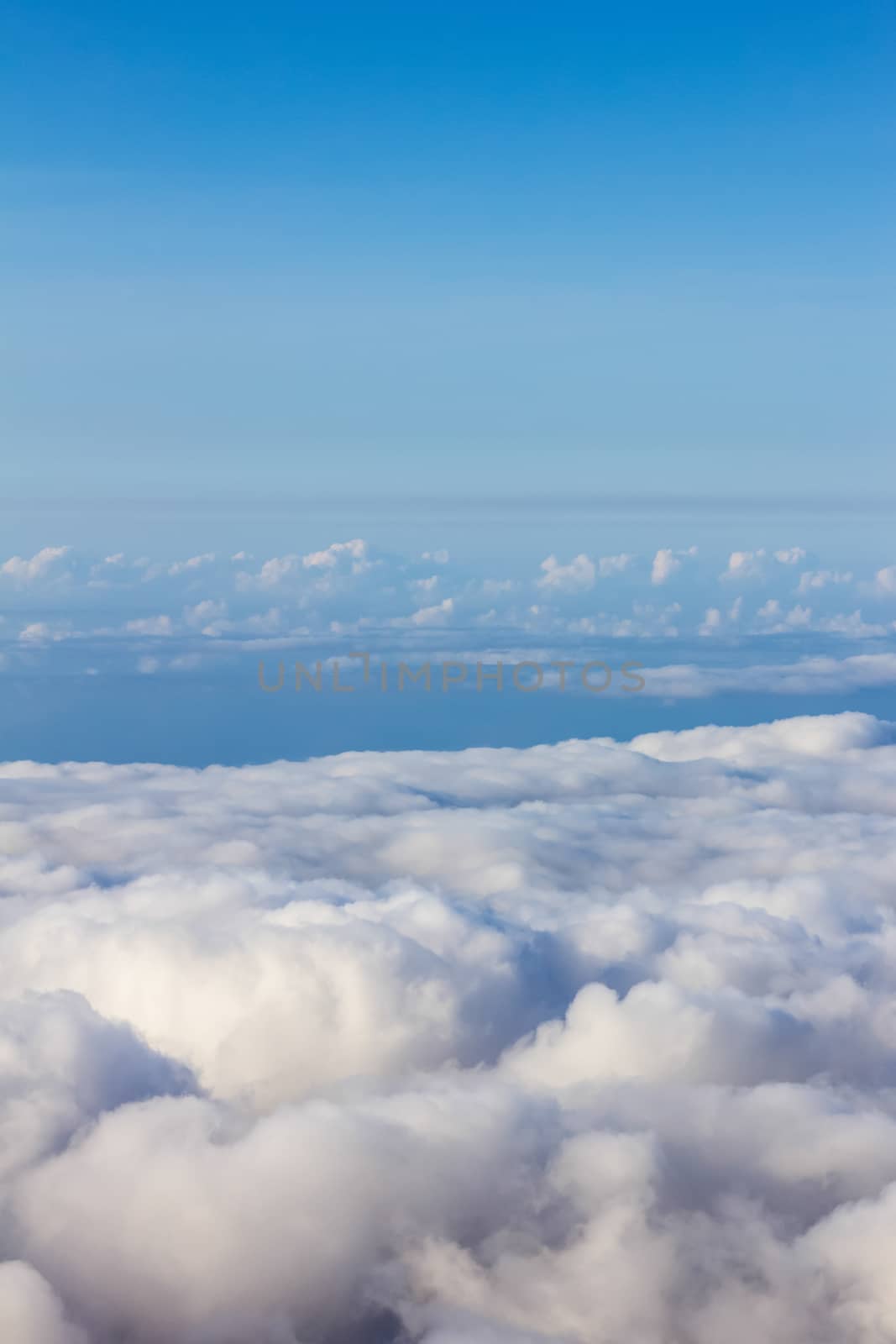 Soft clouds over view from airplane flying