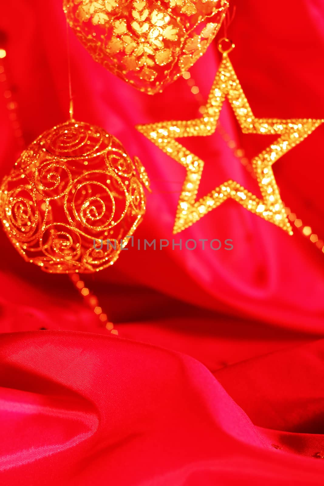 Golden christmas decor on red fabric background