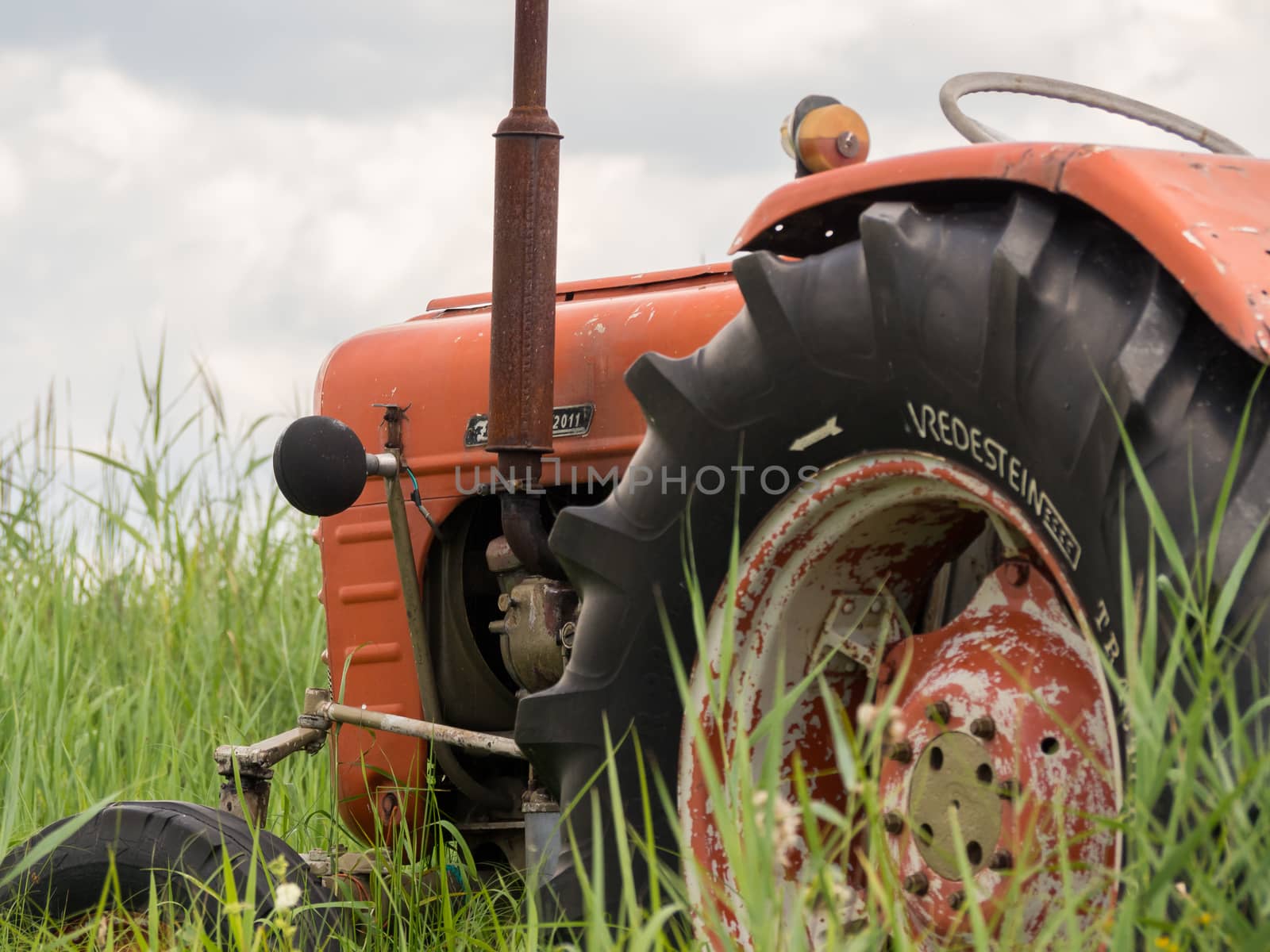 Closeup of an old rusty traktor in a field in Weerribben